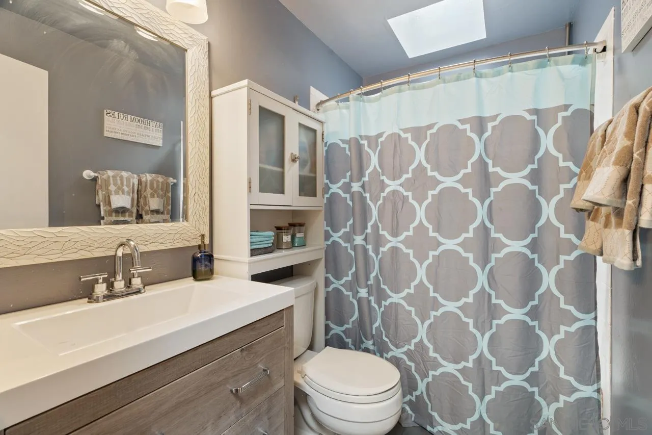 497 Mountain View Road El Cajon, CA 92021 - Photo 12 of 30 a bathroom with a sink toilet and shower