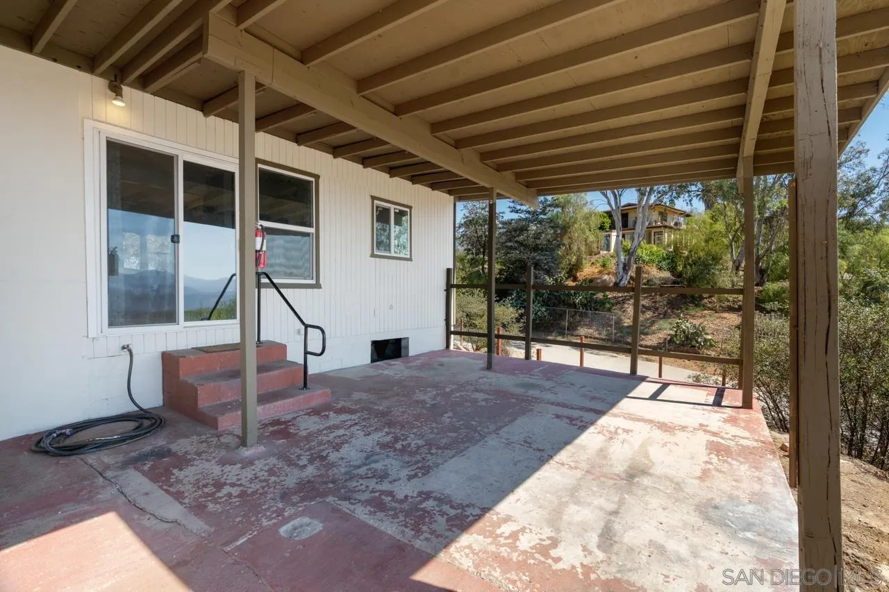 497 Mountain View Road El Cajon, CA 92021 - Photo 17 of 30 a view of a porch with furniture and a backyard