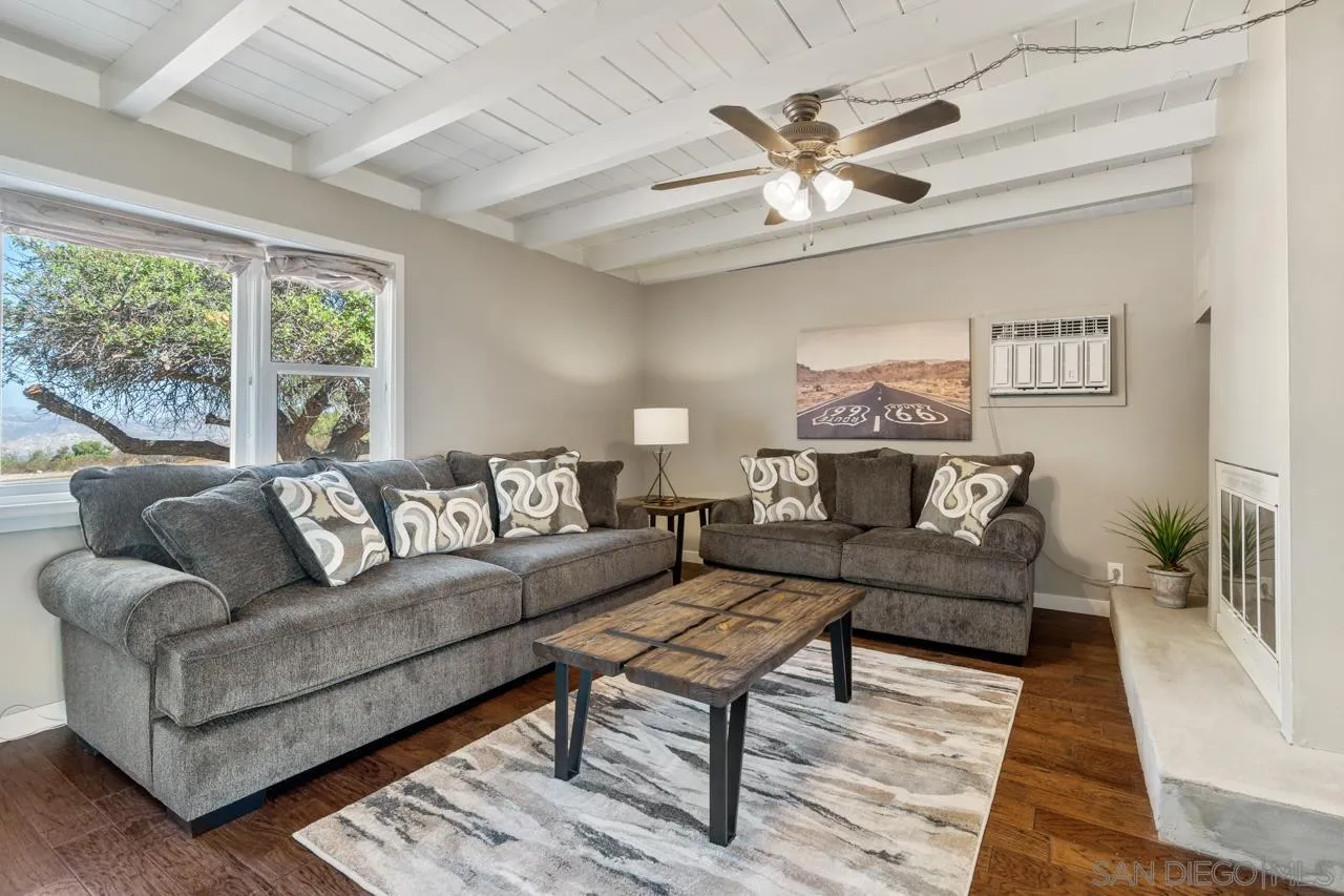 497 Mountain View Road El Cajon, CA 92021 - Photo 4 of 30 a living room with furniture a chandelier and a rug