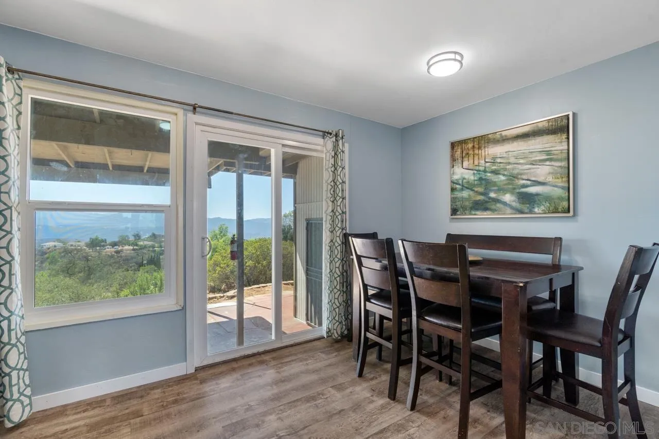 497 Mountain View Road El Cajon, CA 92021 - Photo 5 of 30 a view of a dining room with furniture large windows and wooden floor