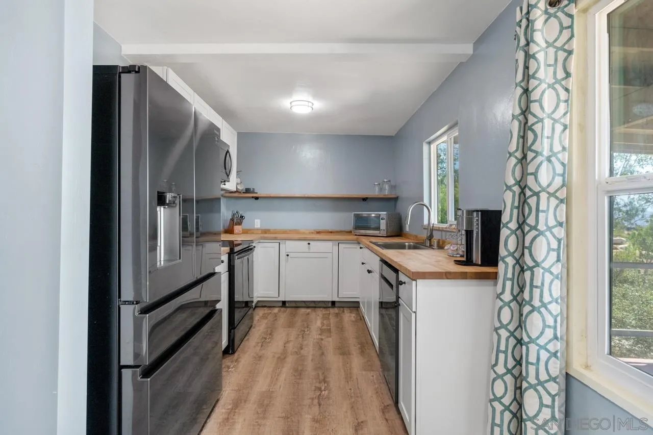 497 Mountain View Road El Cajon, CA 92021 - Photo 7 of 30 a kitchen with a refrigerator and a sink
