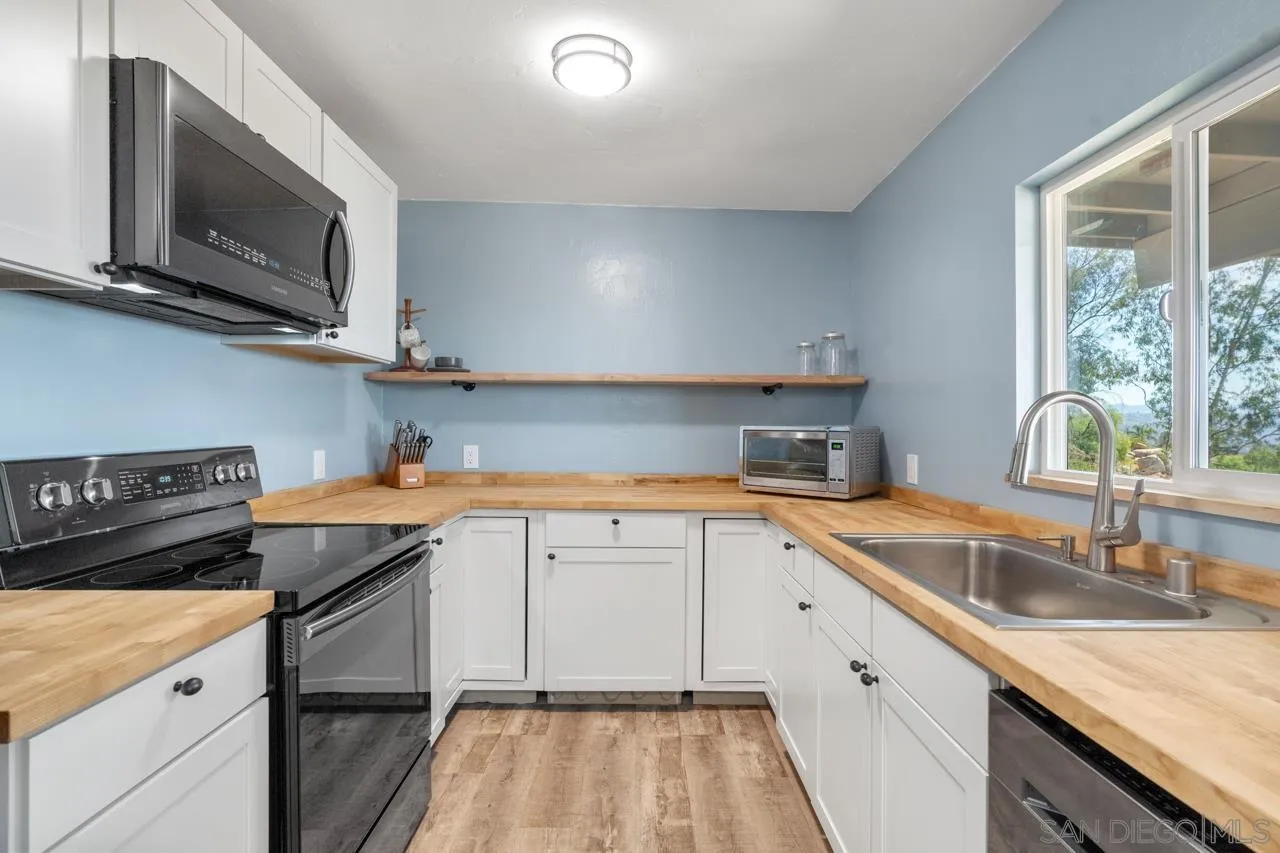 497 Mountain View Road El Cajon, CA 92021 - Photo 8 of 30 a kitchen that has a sink and a stove
