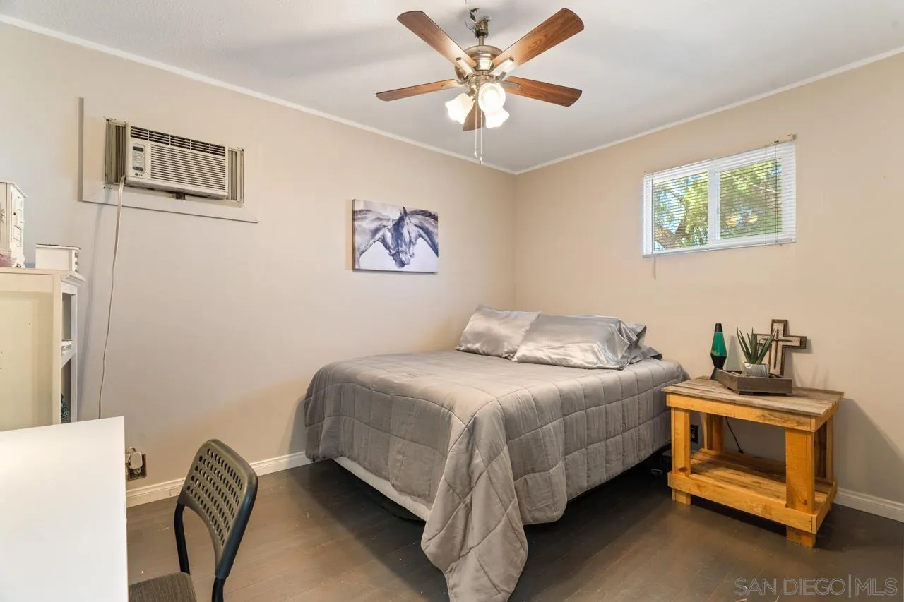 497 Mountain View Road El Cajon, CA 92021 - Photo 10 of 30 a bedroom with a bed and a chandelier