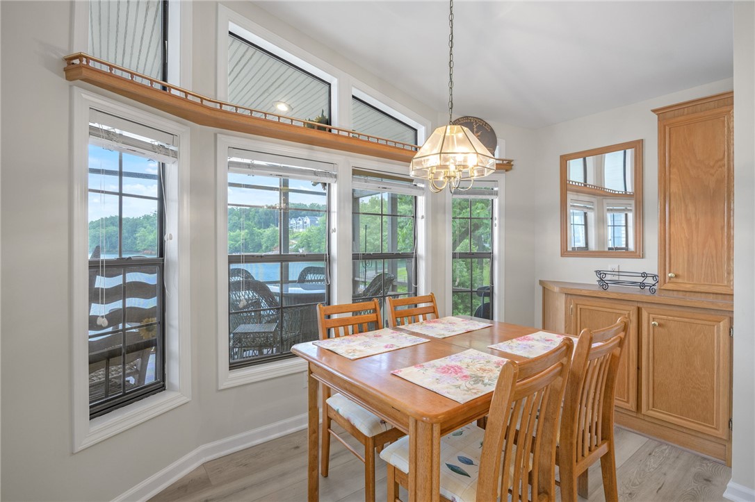 1230 Melton Road, Unit 25 West Union, SC 29696 - Photo 5 of 46 A well-lit dining area offers a charming view of the waterfront through multiple windows, perfect for daily meals.