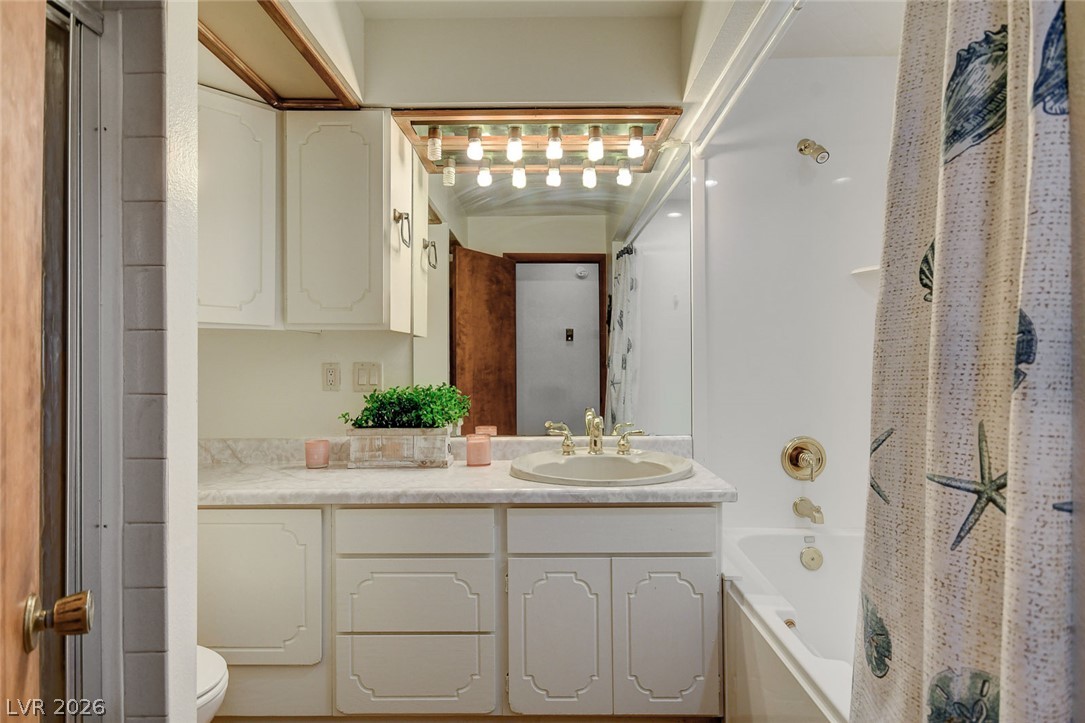 1920 Bowman Road Logandale, NV 89021 - Photo 38 of 68 White cabinetry paired with a marble-patterned countertop anchors this functional bathroom space.