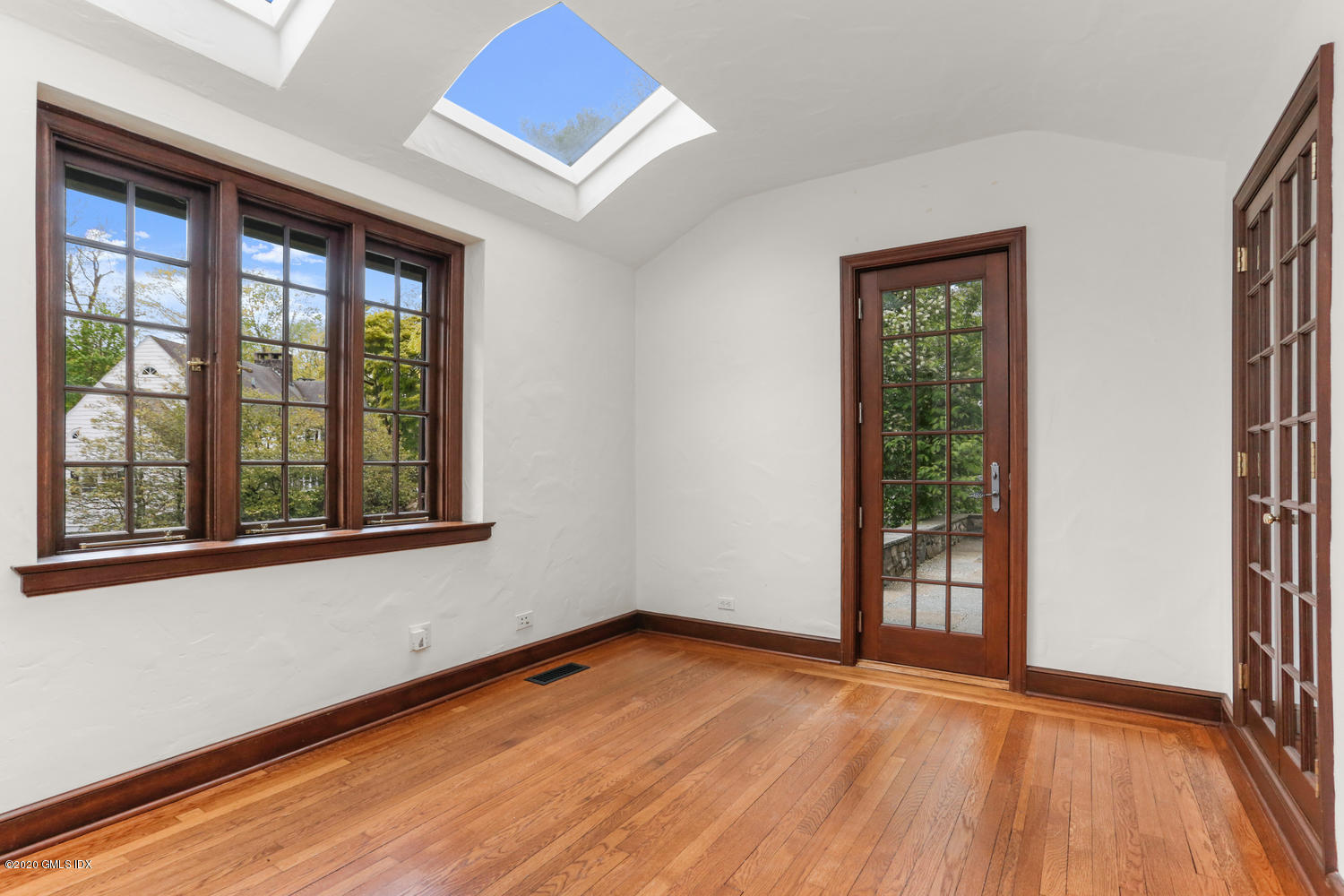 1 Spring Road Greenwich, CT 06830 - Photo 15 of 45 an empty room with wooden floor and windows