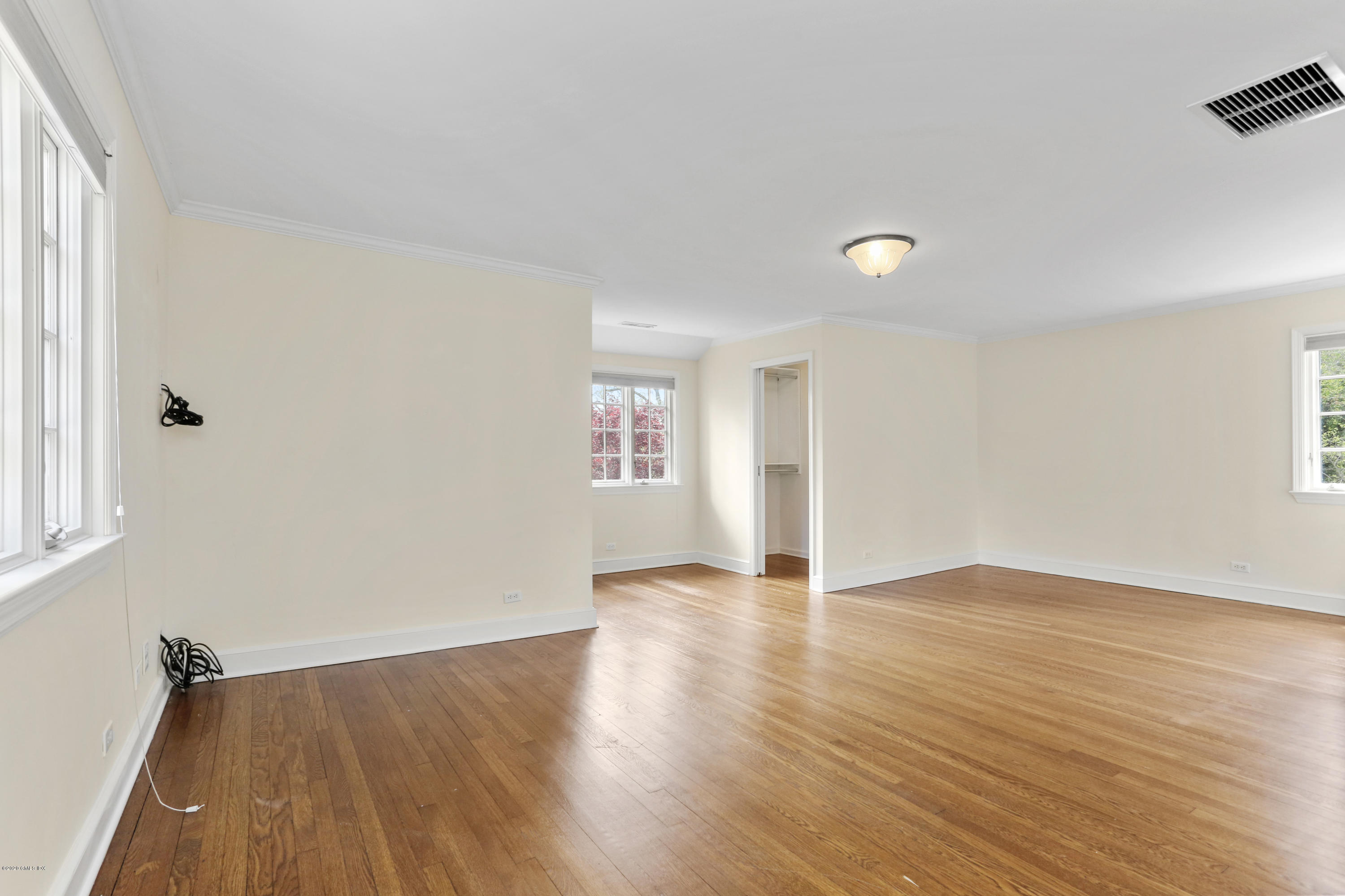 1 Spring Road Greenwich, CT 06830 - Photo 19 of 45 an empty room with wooden floor and windows