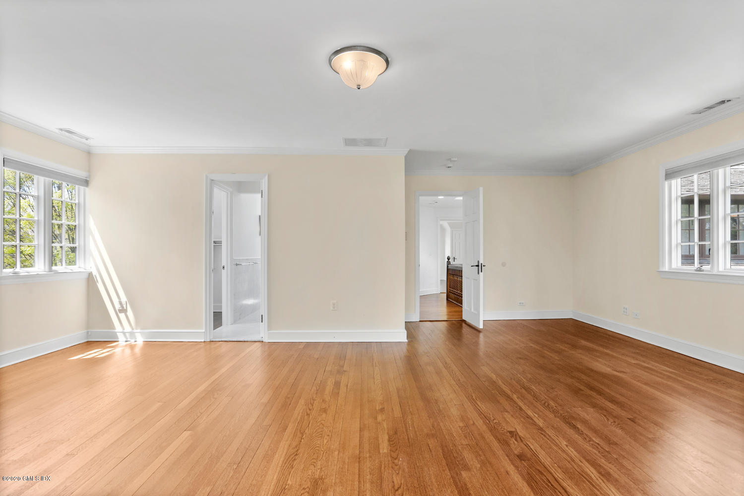 1 Spring Road Greenwich, CT 06830 - Photo 20 of 45 an empty room with wooden floor and windows