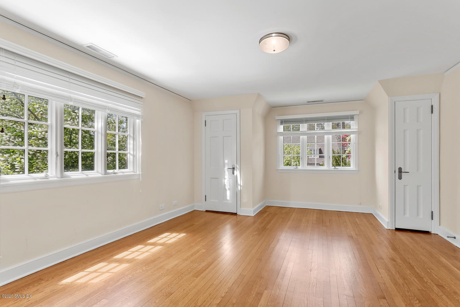 1 Spring Road Greenwich, CT 06830 - Photo 25 of 45 an empty room with wooden floor and windows