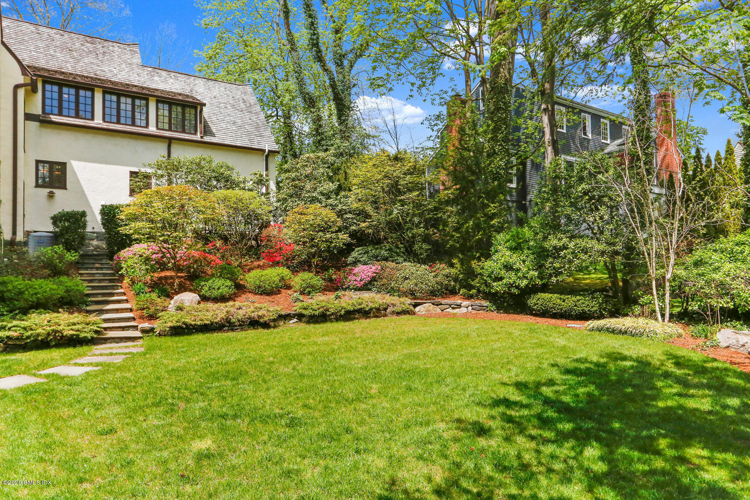 1 Spring Road Greenwich, CT 06830 - Photo 37 of 45 a view of a house with a garden and pathway