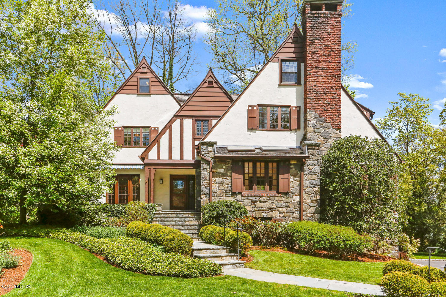 1 Spring Road Greenwich, CT 06830 - Photo 43 of 45 a front view of a house with a yard