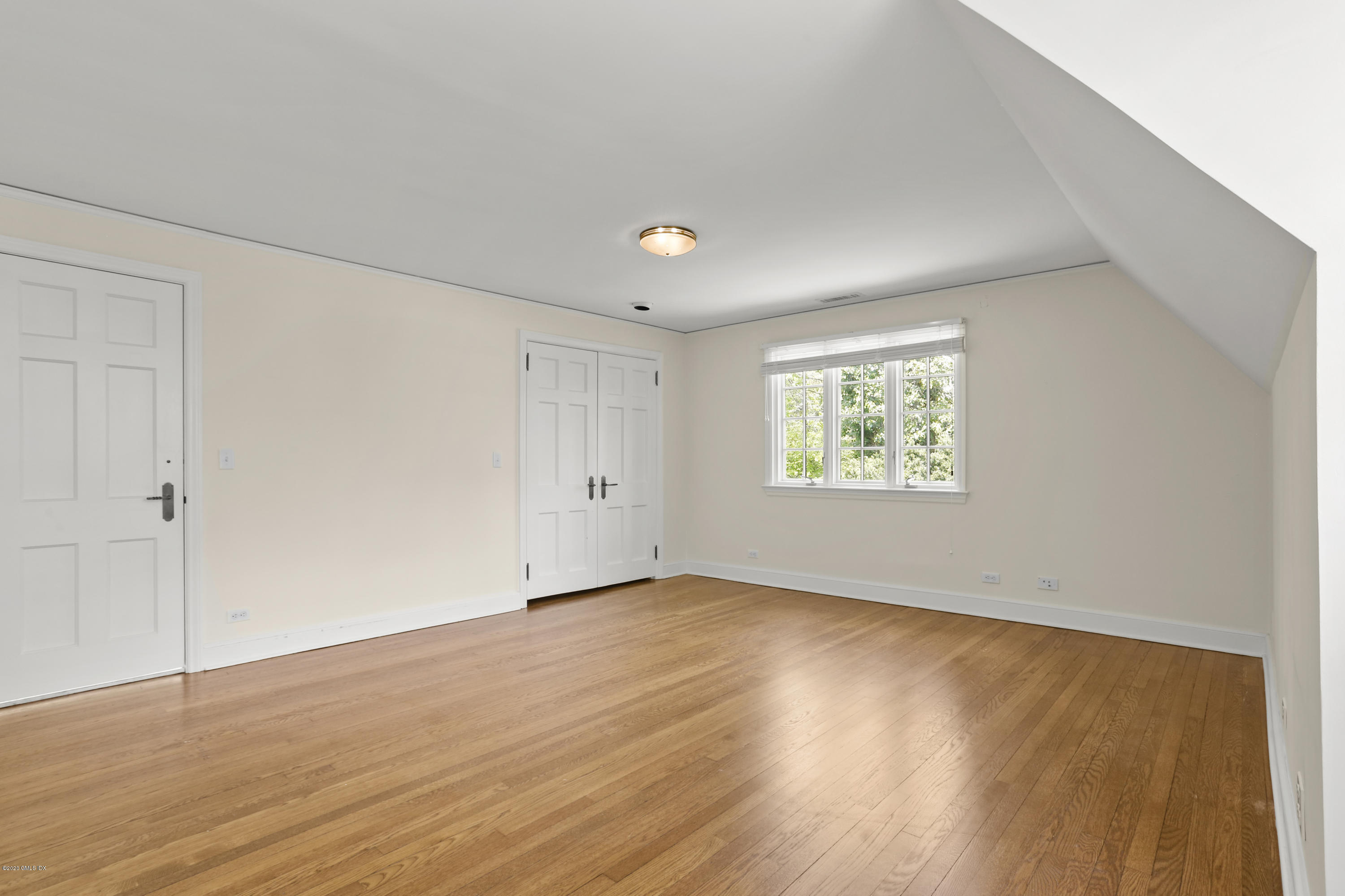 1 Spring Road Greenwich, CT 06830 - Photo 45 of 45 a view of an empty room with wooden floor and a window