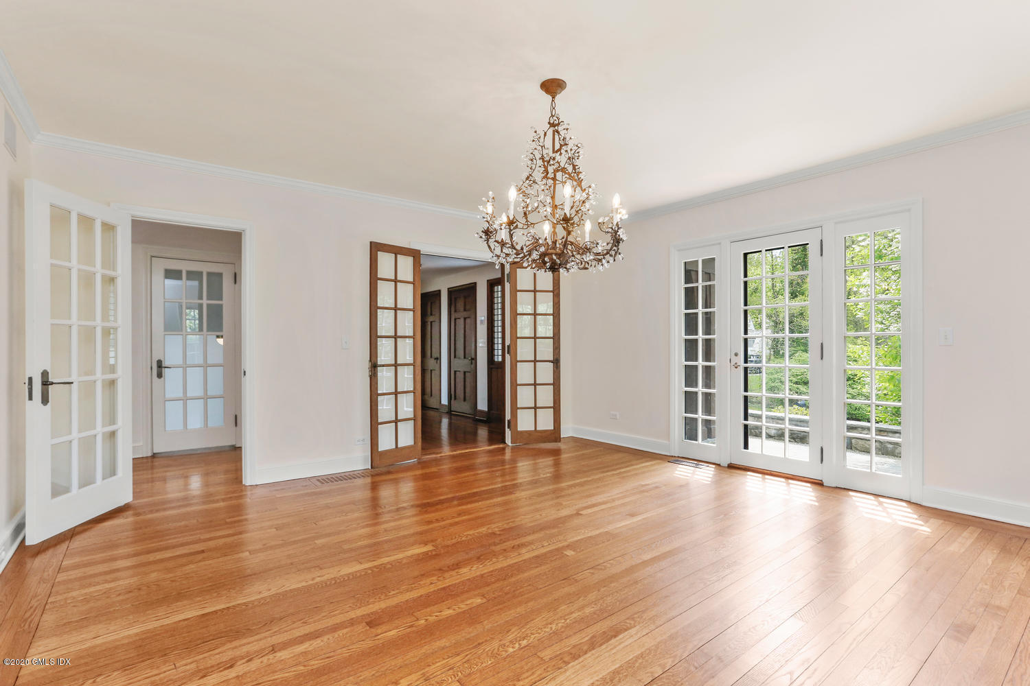 1 Spring Road Greenwich, CT 06830 - Photo 5 of 45 a view of an empty room with wooden floor and a window