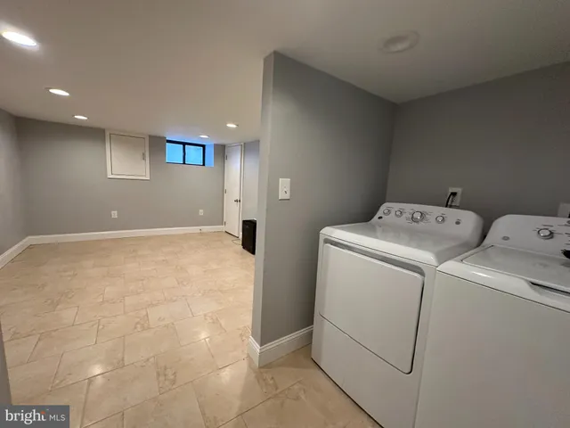 a view of storage and utility room with washer and dryer
