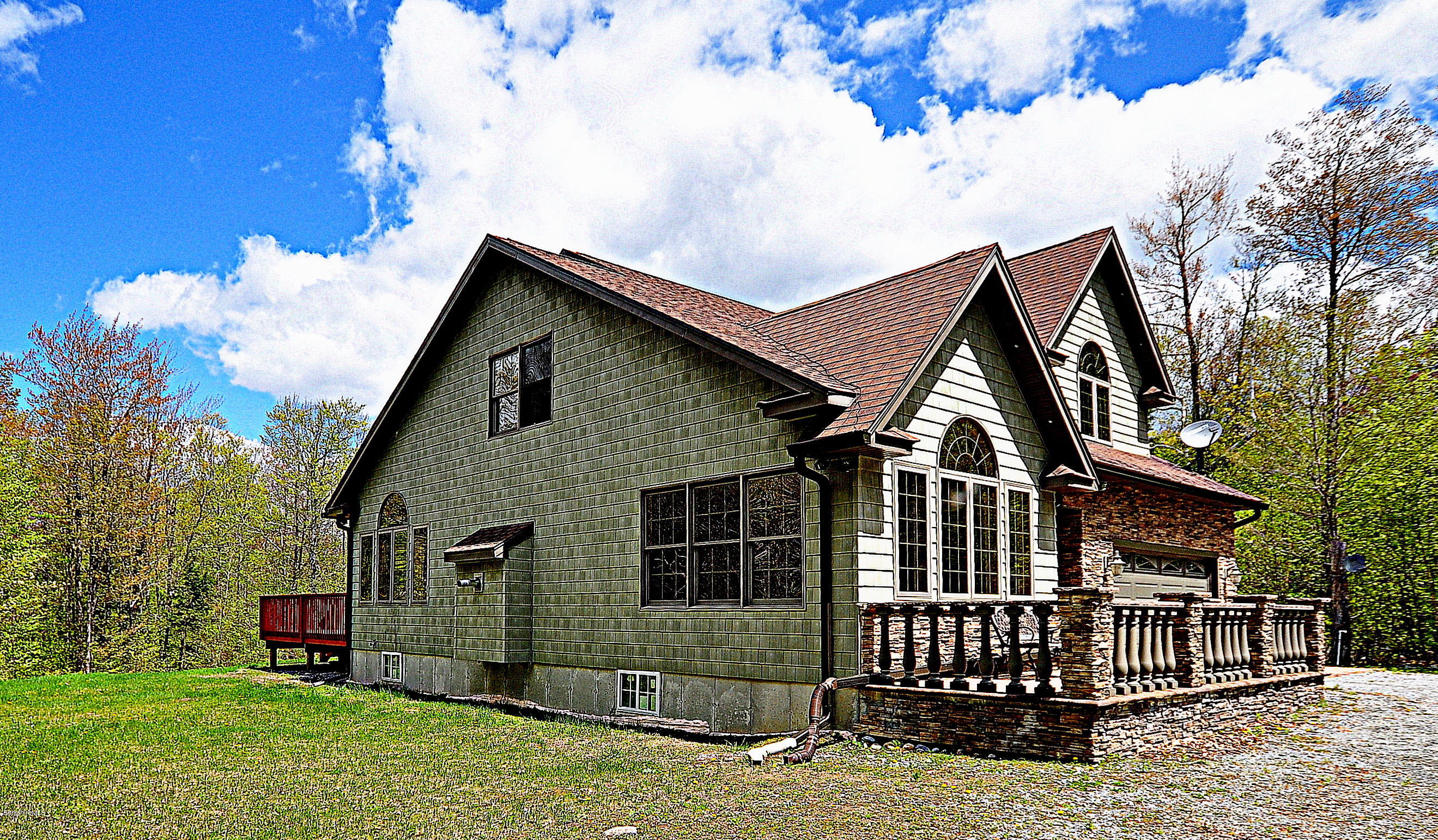 317 Skyline Ridge Road Becket, MA 01223 - Photo 1 of 29 a front view of a house with garden