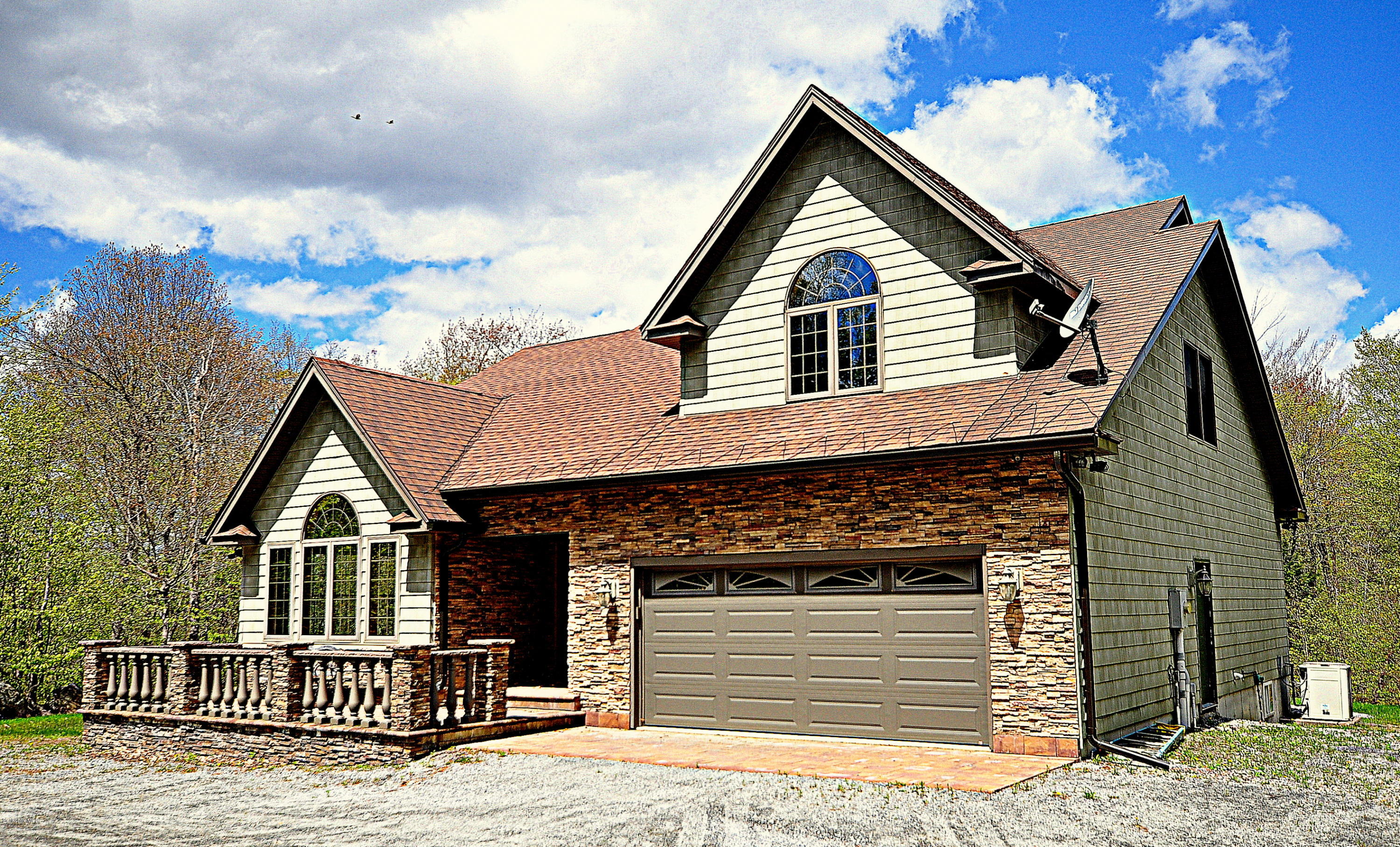 317 Skyline Ridge Road Becket, MA 01223 - Photo 2 of 29 a front view of a house with a yard