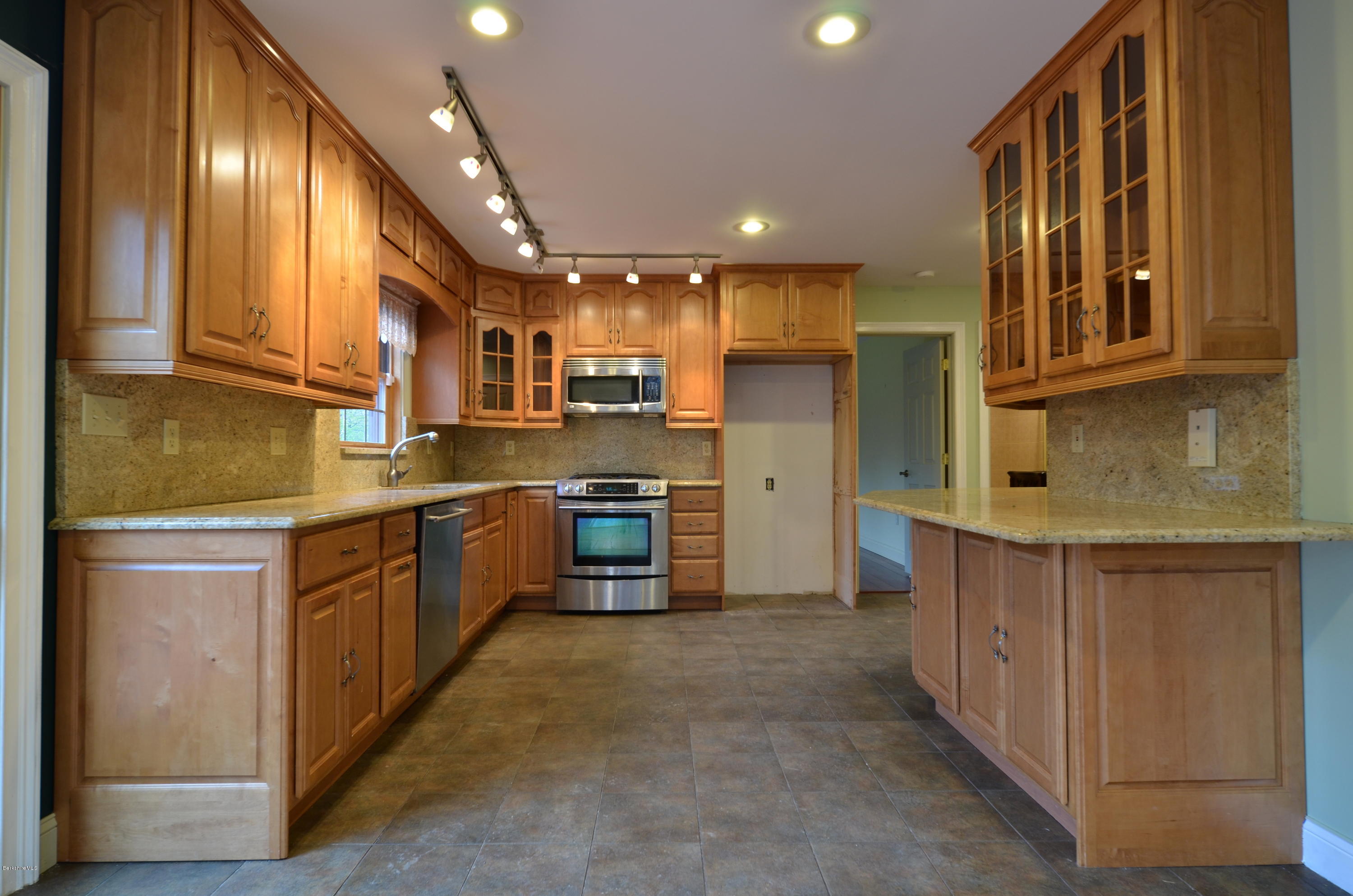 317 Skyline Ridge Road Becket, MA 01223 - Photo 12 of 29 a kitchen with stainless steel appliances granite countertop a refrigerator a stove and a sink