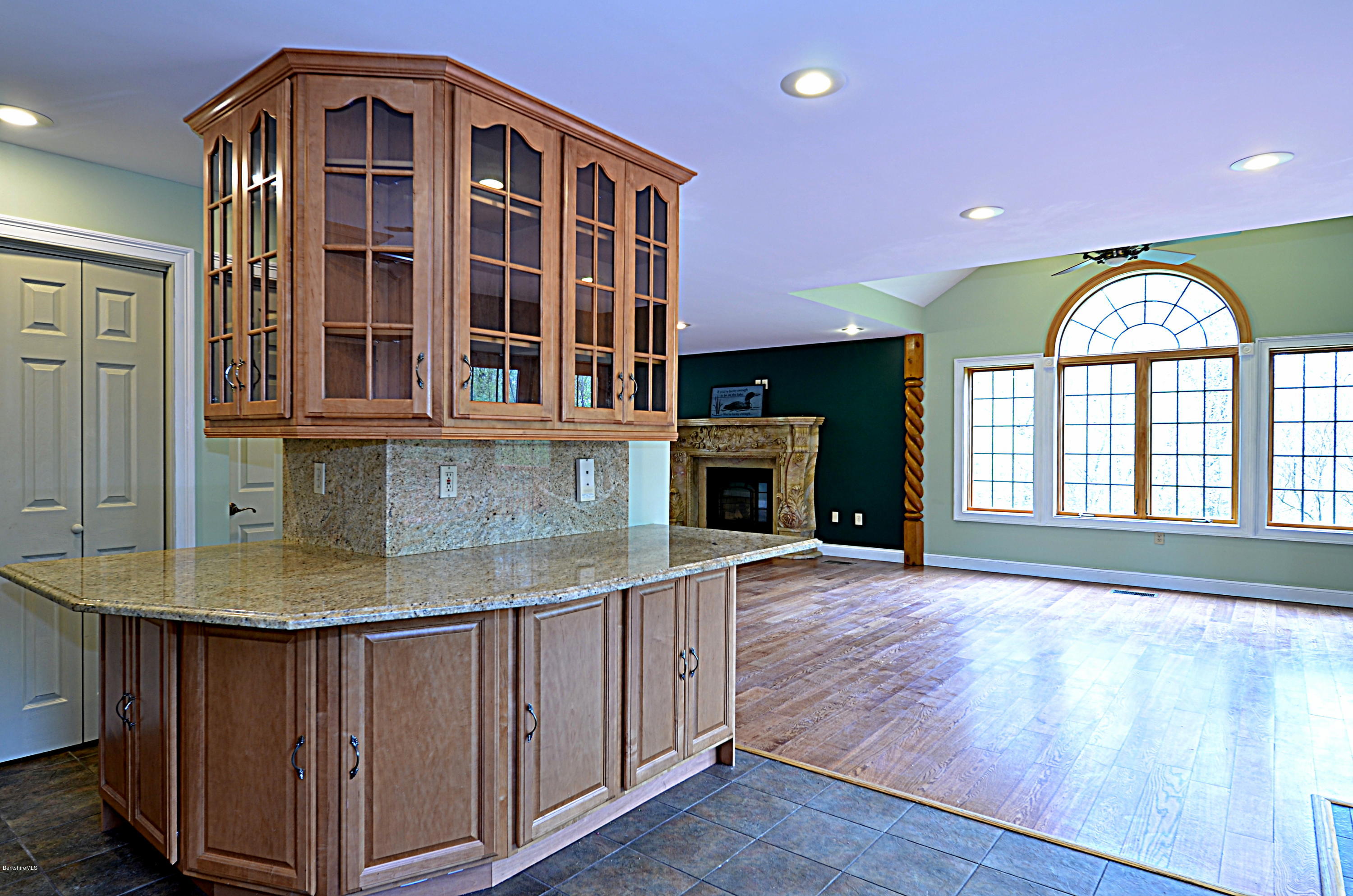 317 Skyline Ridge Road Becket, MA 01223 - Photo 13 of 29 an open kitchen with cabinets and a fireplace
