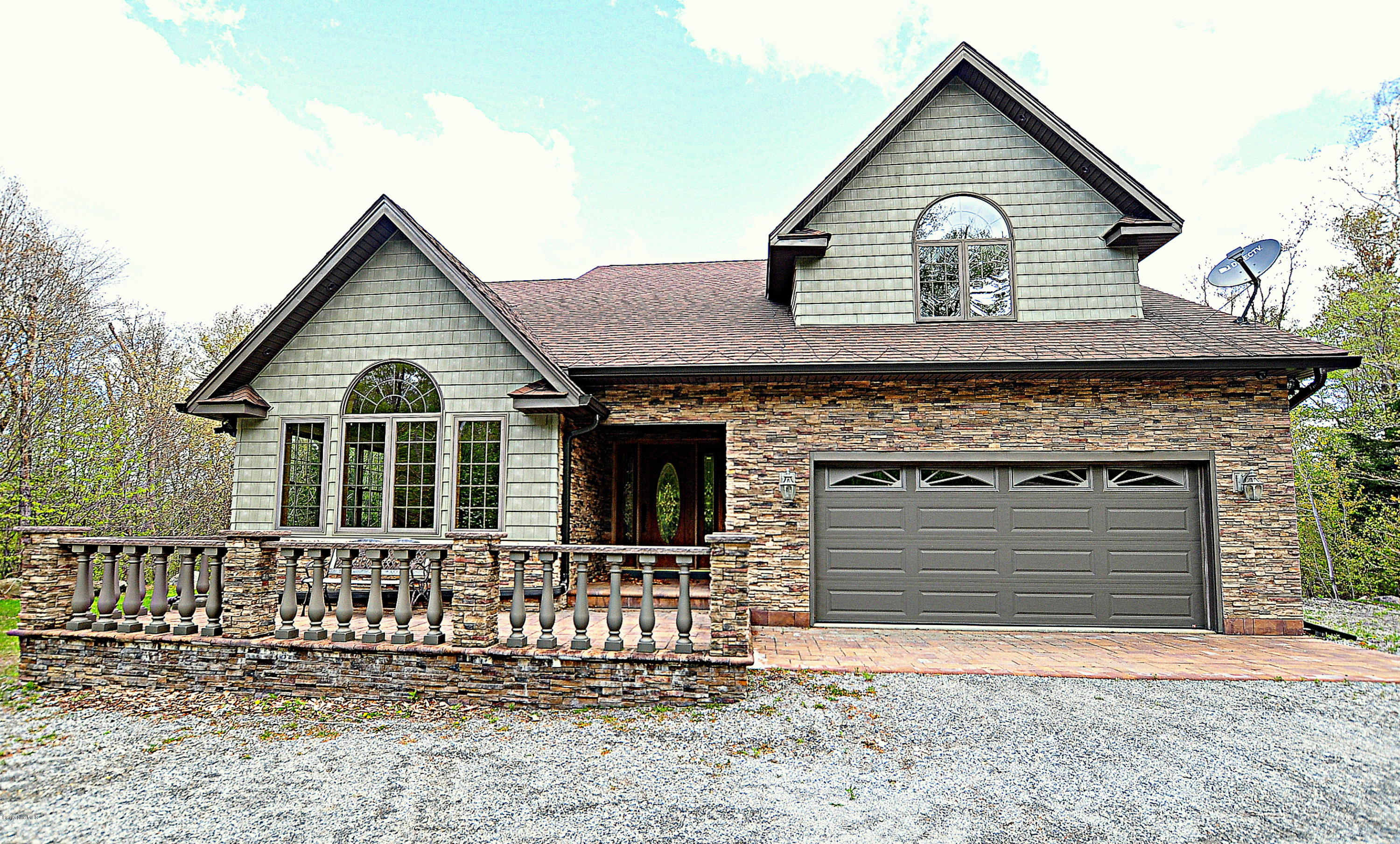 317 Skyline Ridge Road Becket, MA 01223 - Photo 3 of 29 a front view of a house with a yard