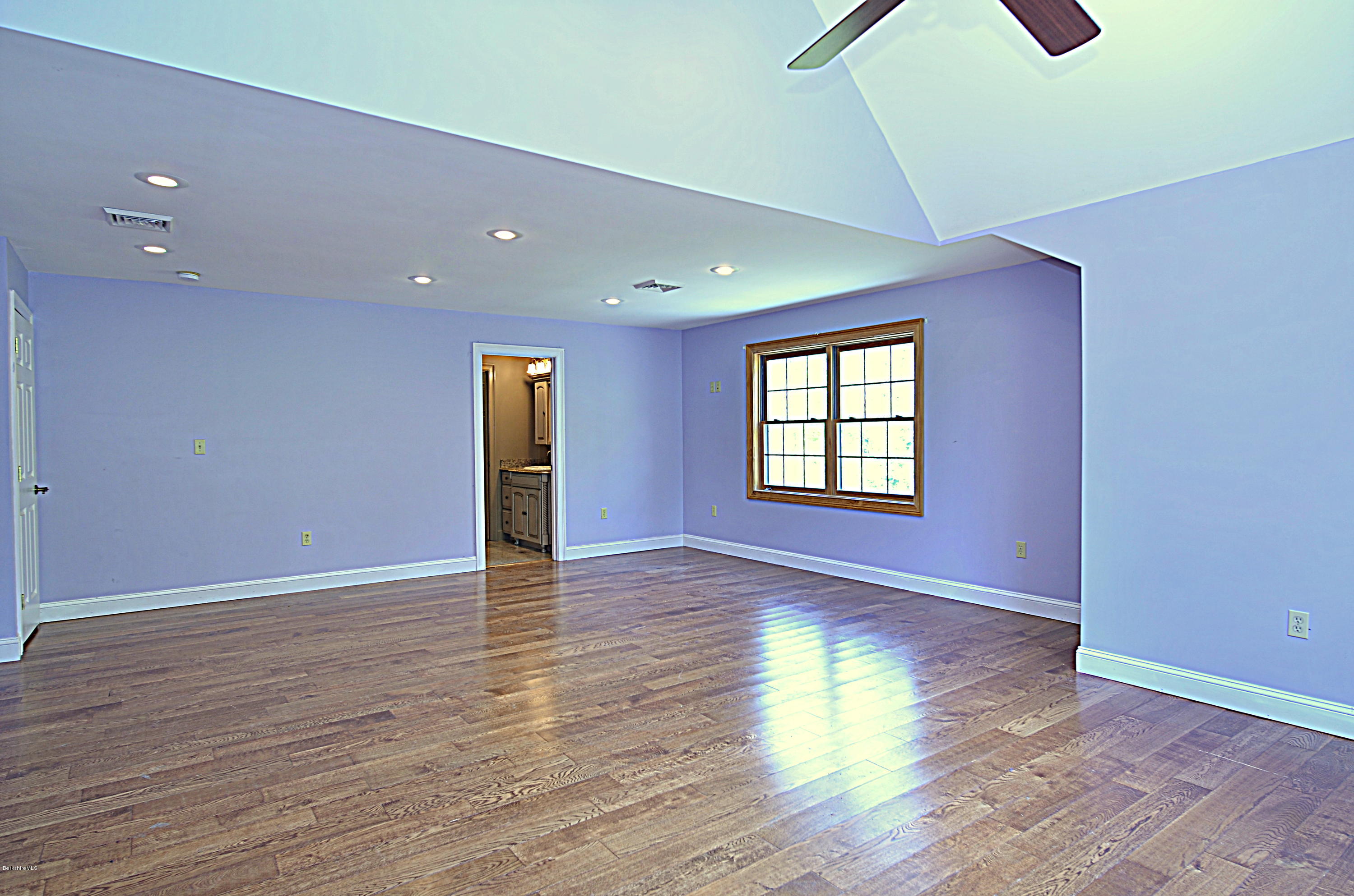 317 Skyline Ridge Road Becket, MA 01223 - Photo 21 of 29 a view of an empty room with wooden floor and a window