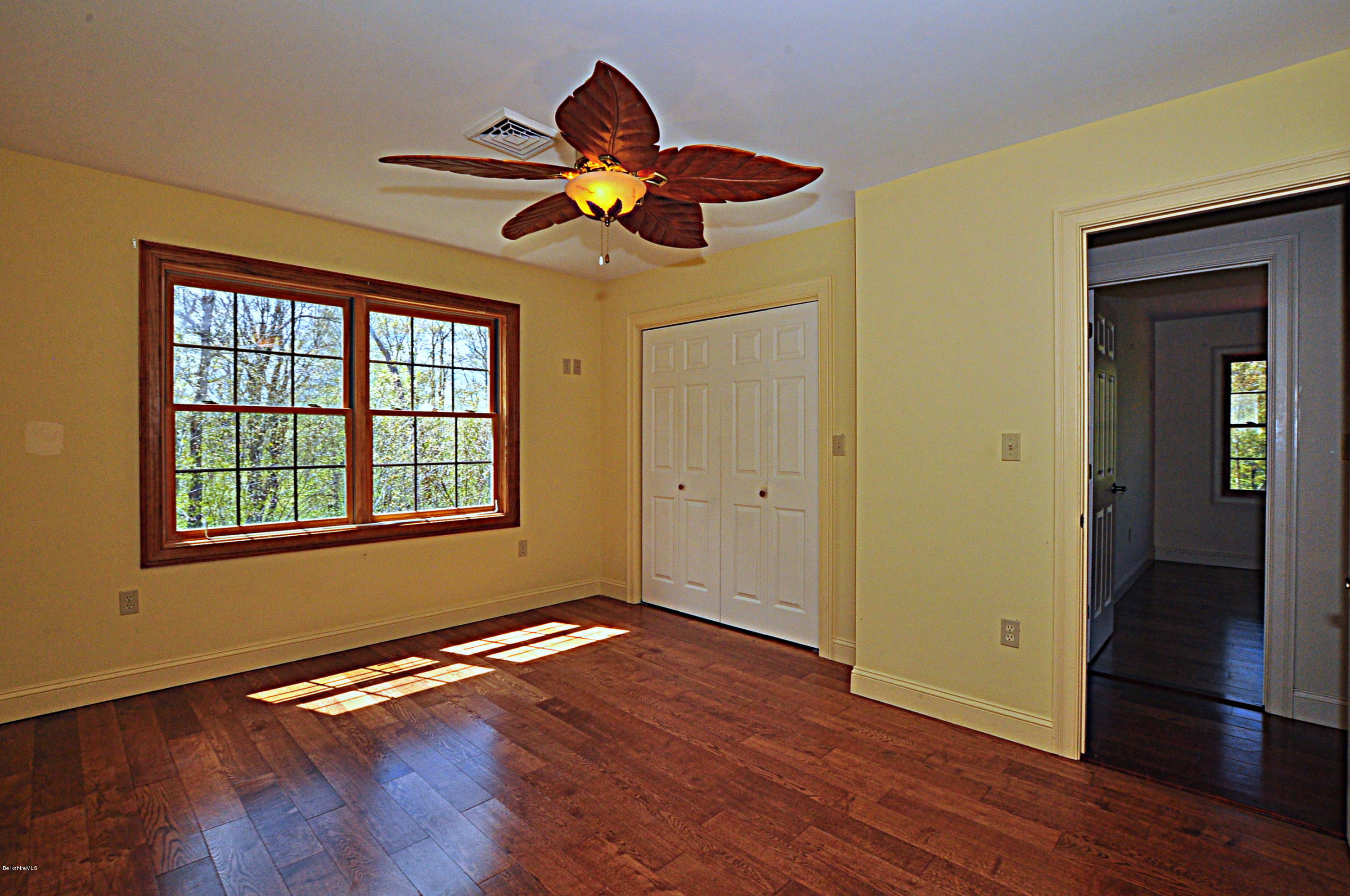 317 Skyline Ridge Road Becket, MA 01223 - Photo 26 of 29 a view of an empty room with wooden floor and a window