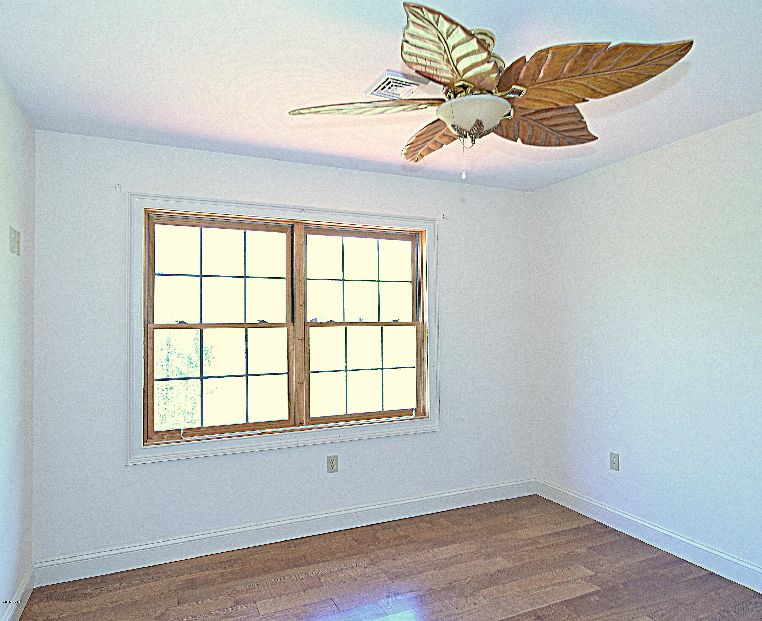 317 Skyline Ridge Road Becket, MA 01223 - Photo 28 of 29 a view of an empty room with wooden floor and a window