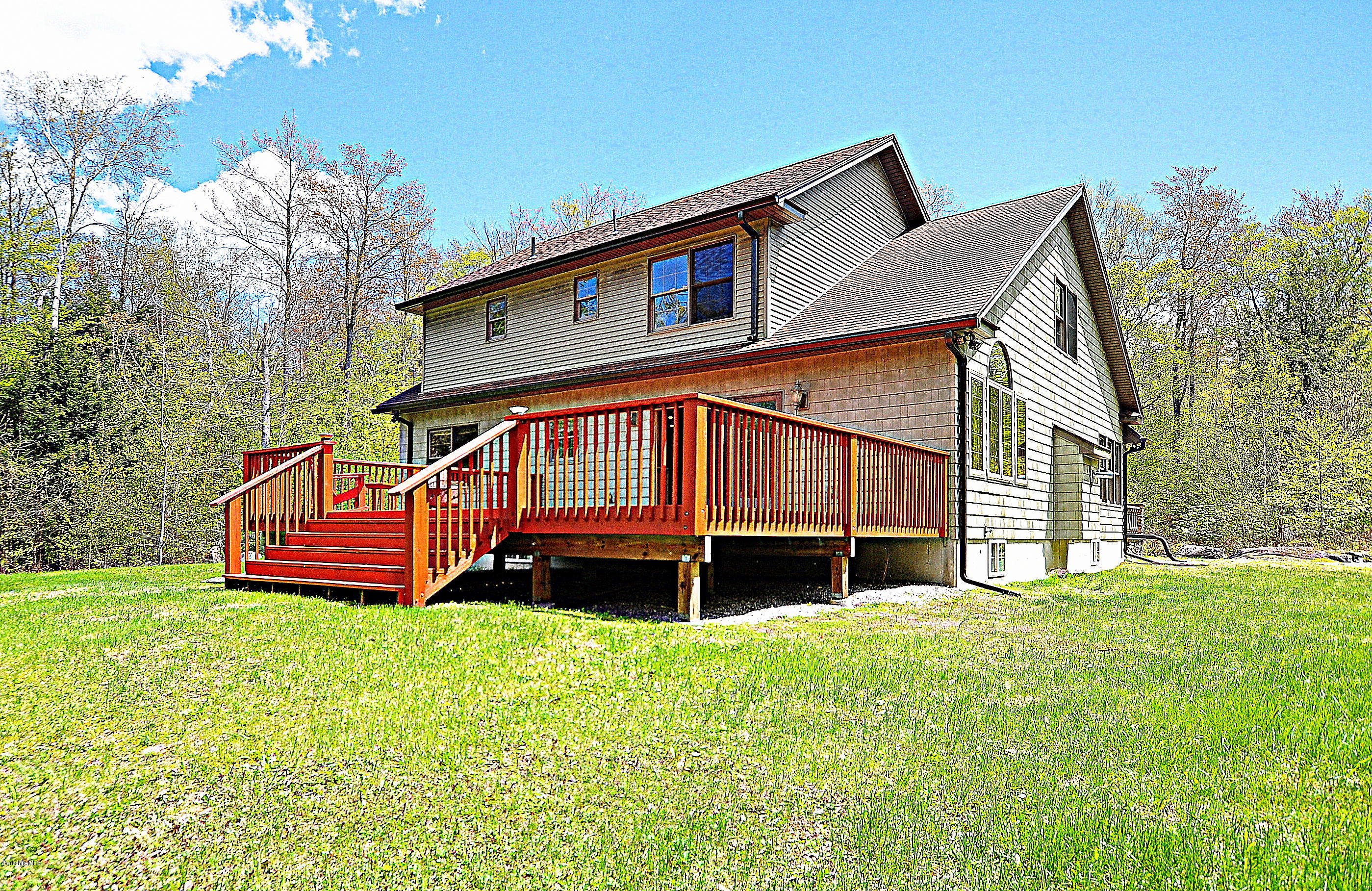 317 Skyline Ridge Road Becket, MA 01223 - Photo 4 of 29 a front view of a house with a yard table and chairs