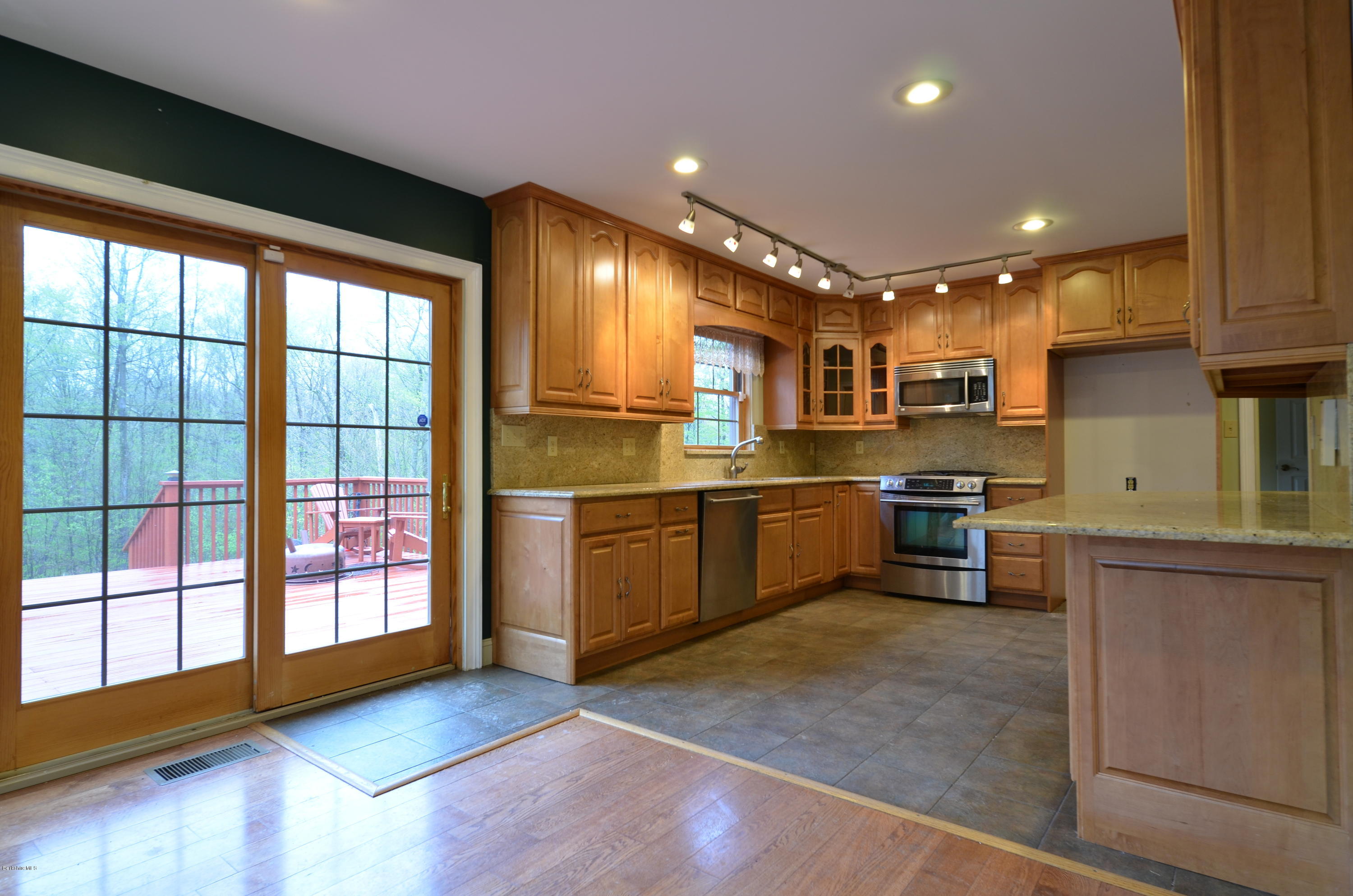 317 Skyline Ridge Road Becket, MA 01223 - Photo 7 of 29 a kitchen with a sink stainless steel appliances and cabinets