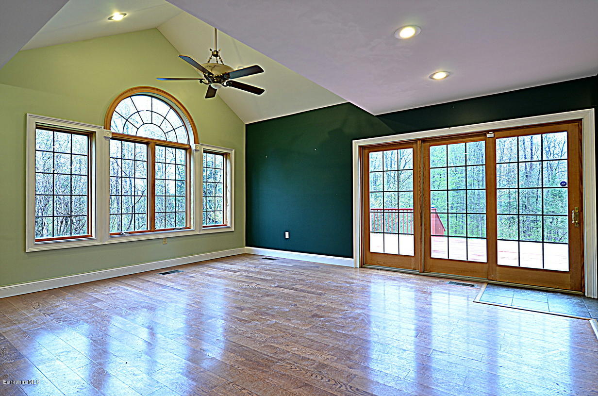 317 Skyline Ridge Road Becket, MA 01223 - Photo 8 of 29 a view of an empty room with a window and wooden floor