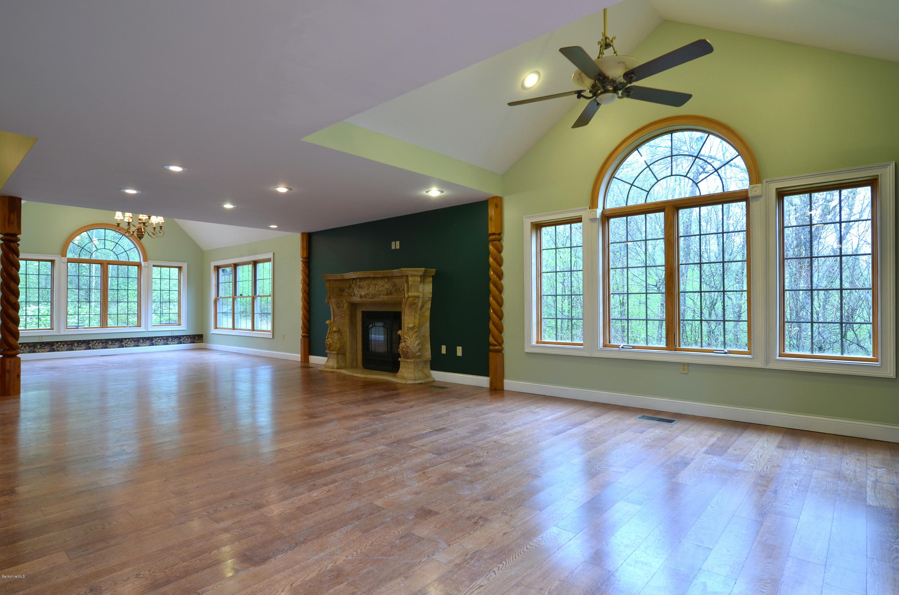 317 Skyline Ridge Road Becket, MA 01223 - Photo 9 of 29 a view of an empty room with wooden floor and a fireplace