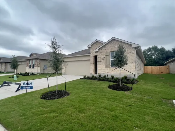 a front view of house with a garden and patio