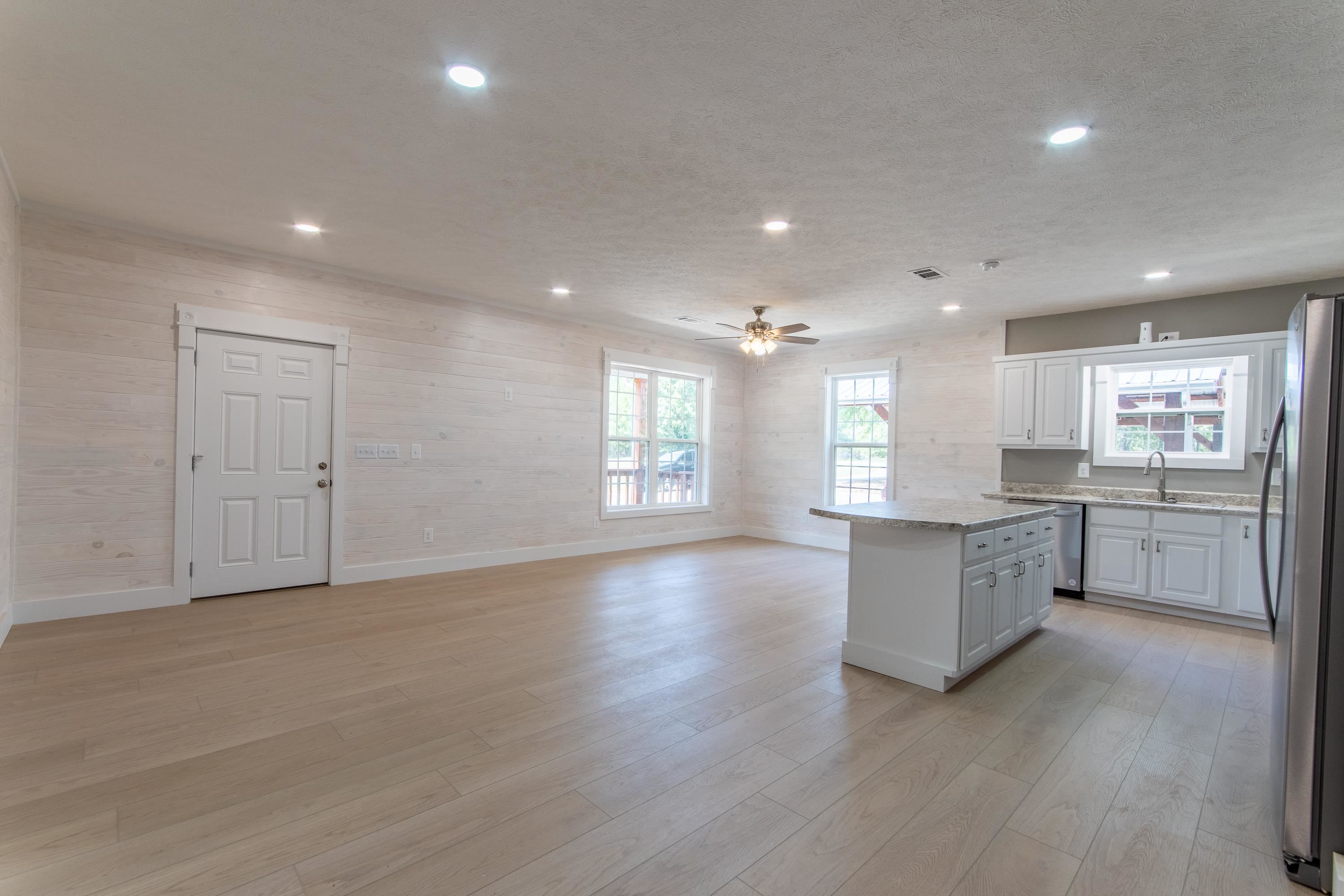 1375 Gin Road Michie, TN 38357 - Photo 13 of 37 Kitchen featuring light wood-type flooring, stainless steel appliances, a kitchen island, sink, and ceiling fan