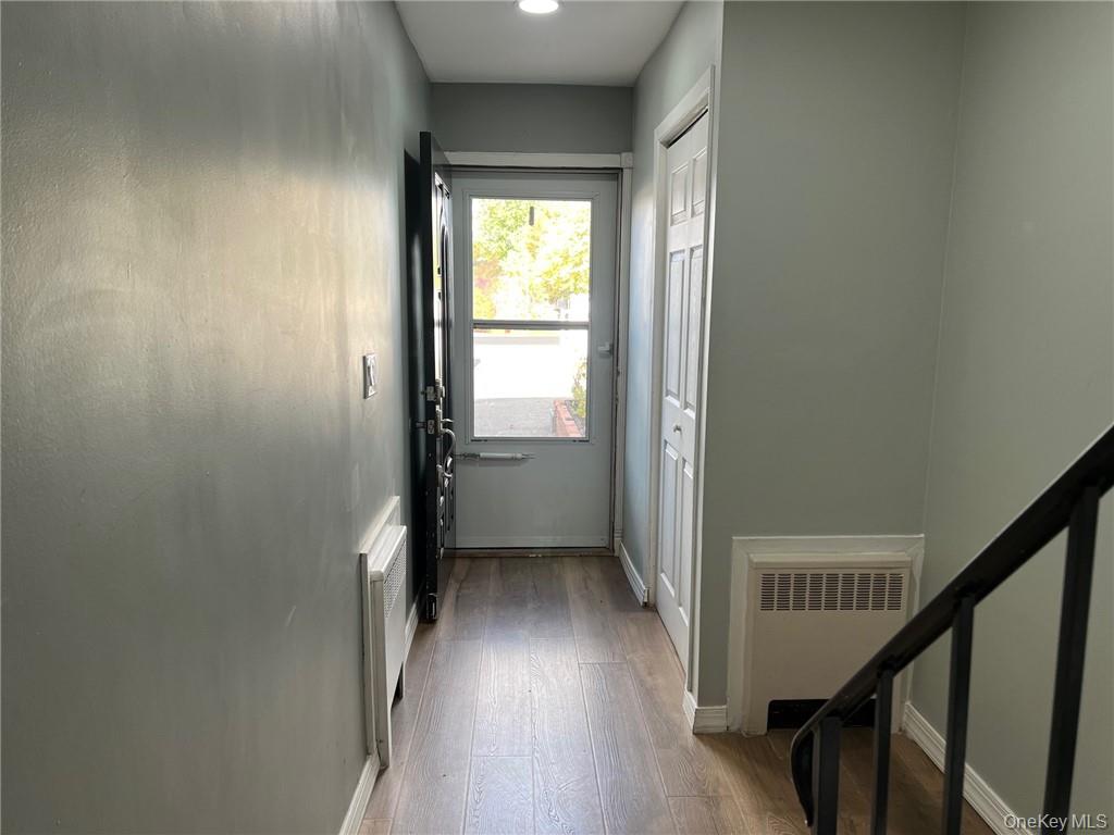 708 Silver Lake-Scotchtown Road Middletown, NY 10941 - Photo 12 of 25 Entryway featuring radiator and light hardwood / wood-style flooring