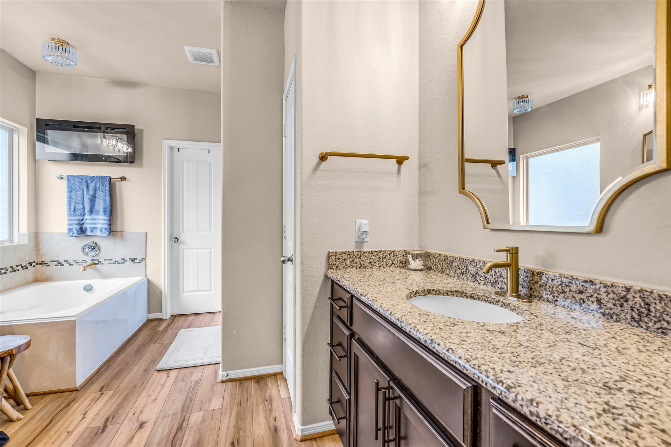 22907 Banff Brook Way Tomball, TX 77375 - Photo 14 of 26 Inside the primary bathroom, you’ll find a soaking tub along with granite countertops that add a refined and durable finish to the space.