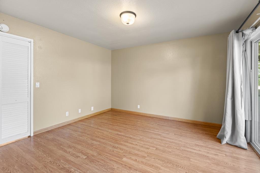 6190 Gerdts Drive San Jose, CA 95135 - Photo 13 of 20 a view of an empty room with wooden floor and a window
