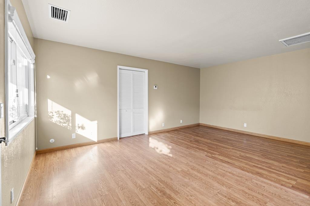 6190 Gerdts Drive San Jose, CA 95135 - Photo 5 of 20 a view of an empty room and window with wooden floor