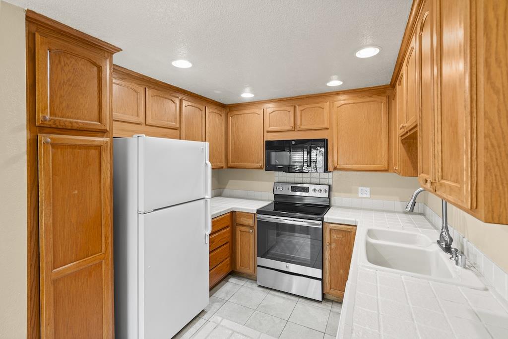 6190 Gerdts Drive San Jose, CA 95135 - Photo 6 of 20 a kitchen with refrigerator cabinets and a sink