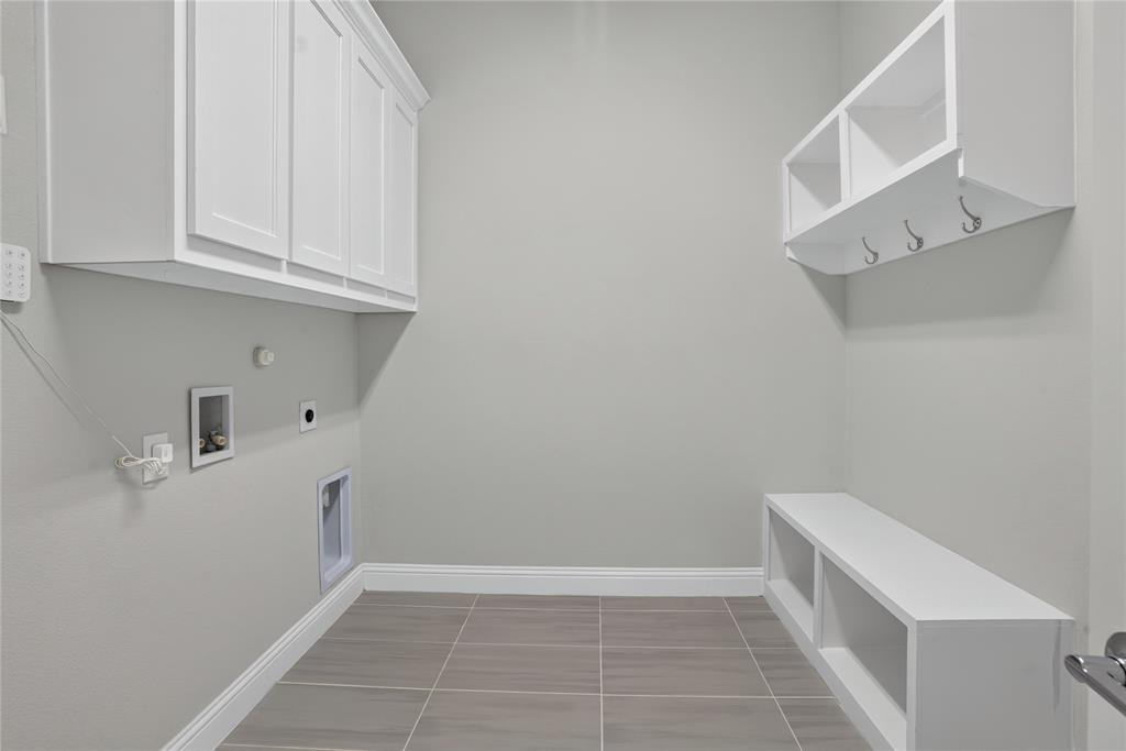 2528 Horsetail Road Frisco, TX 75033 - Photo 29 of 39 Utility room with Custom mud bench area is right by the kitchen corner to conveniently enter and exit to your attached covered garage