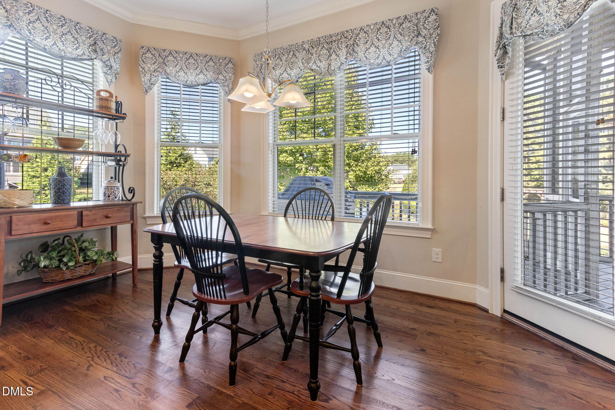 7740 Wilderness Road Raleigh, NC 27613 - Photo 8 of 47 a view of a dining room with furniture and wooden floor