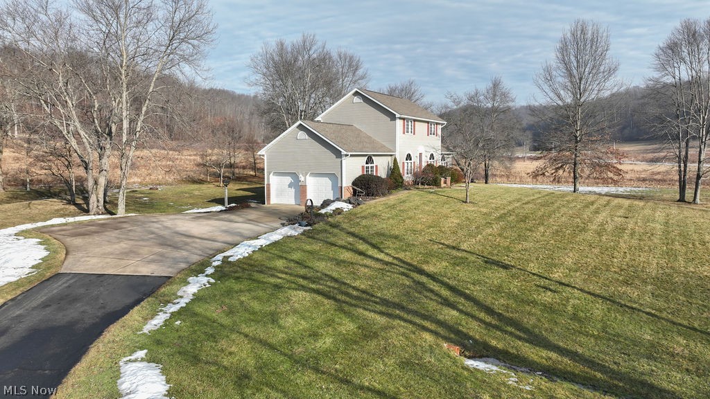 4848 Fette Road Dennison, OH 44621 - Photo 8 of 48 View of side of home featuring driveway, a lawn, and a garage