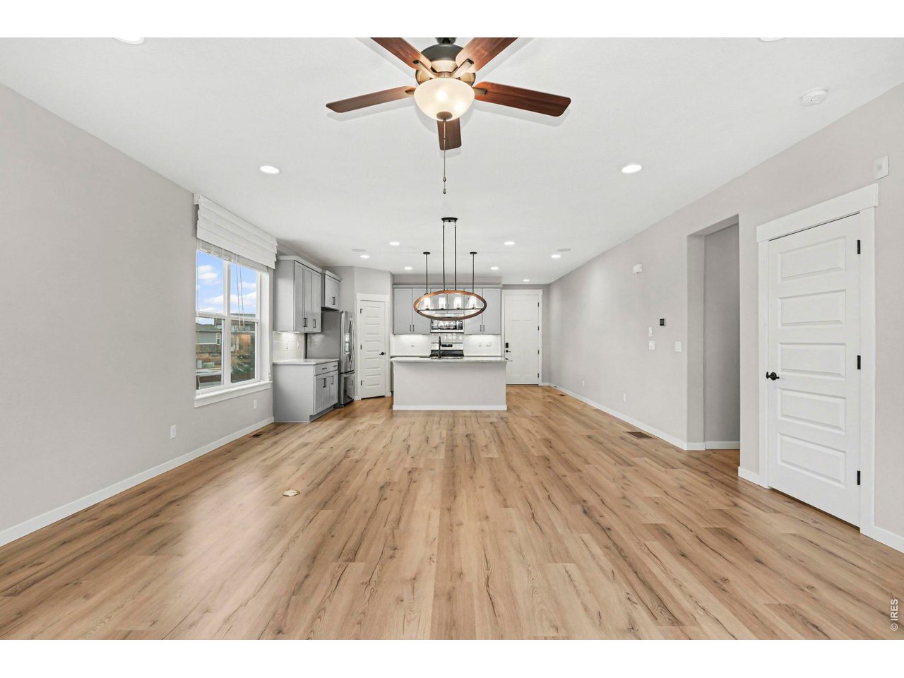 2124 Glean Court Windsor, CO 80550 - Photo 11 of 40 a view of an empty room with window and wooden floor