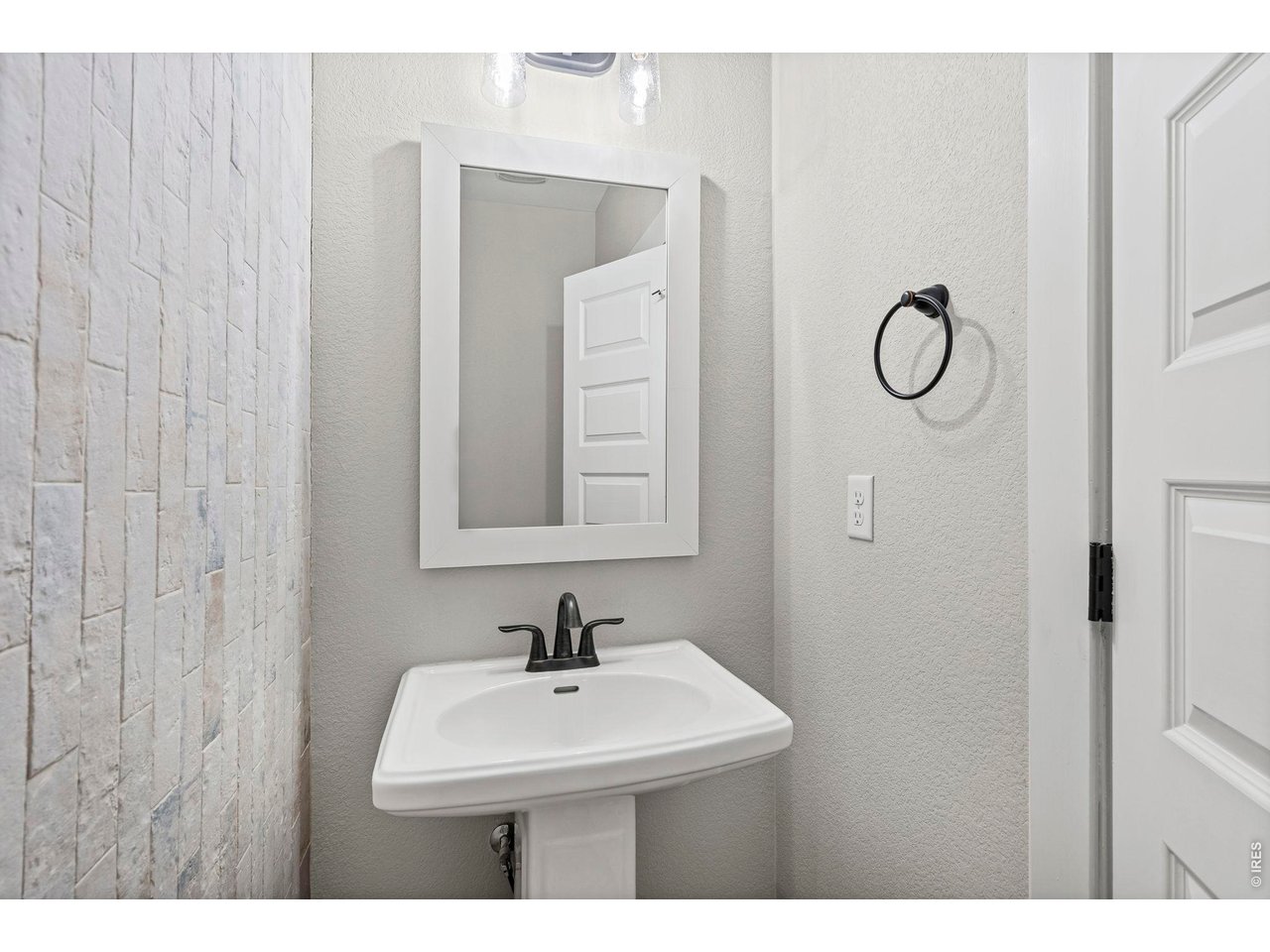 2124 Glean Court Windsor, CO 80550 - Photo 15 of 40 a bathroom with a sink and mirror