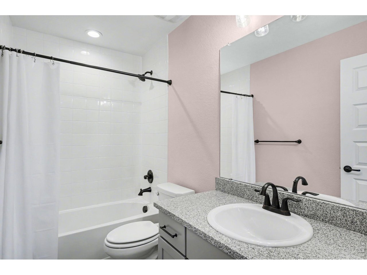 2124 Glean Court Windsor, CO 80550 - Photo 23 of 40 a bathroom with a granite countertop sink toilet a shower and a mirror