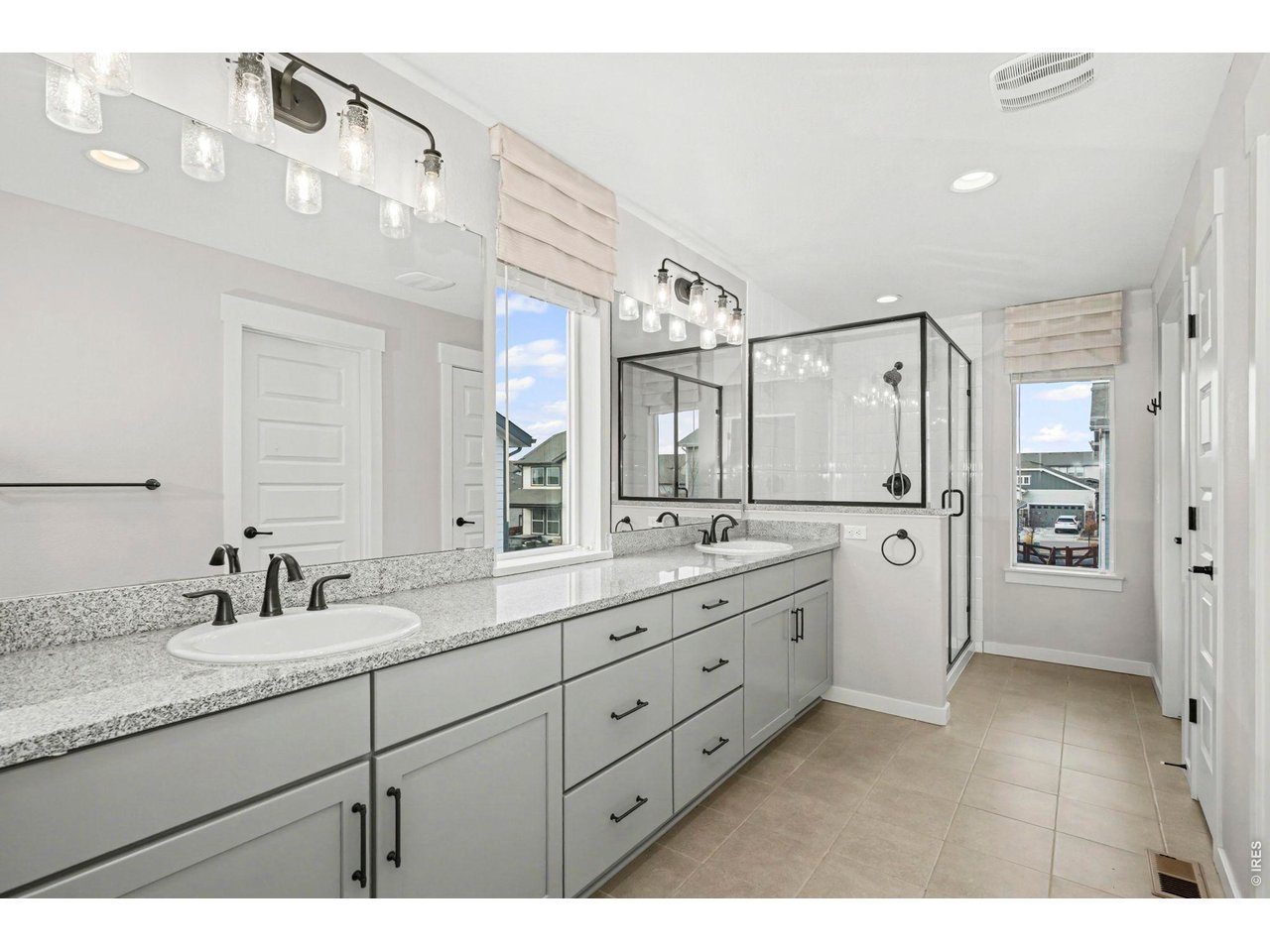 2124 Glean Court Windsor, CO 80550 - Photo 30 of 40 a bathroom with a granite countertop sink mirror and double