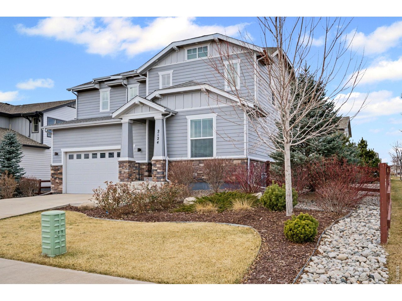 2124 Glean Court Windsor, CO 80550 - Photo 3 of 40 a front view of a house with garden
