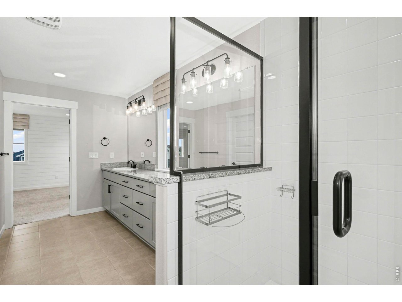 2124 Glean Court Windsor, CO 80550 - Photo 32 of 40 a bathroom with a double vanity sink mirror and shower