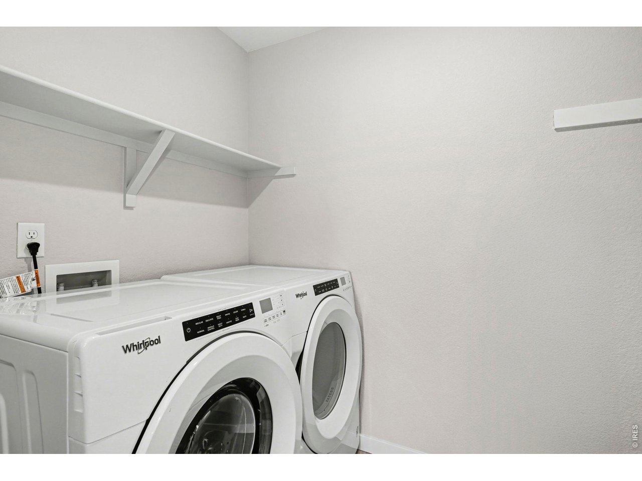 2124 Glean Court Windsor, CO 80550 - Photo 33 of 40 a view of washer and dryer with kitchen in the background