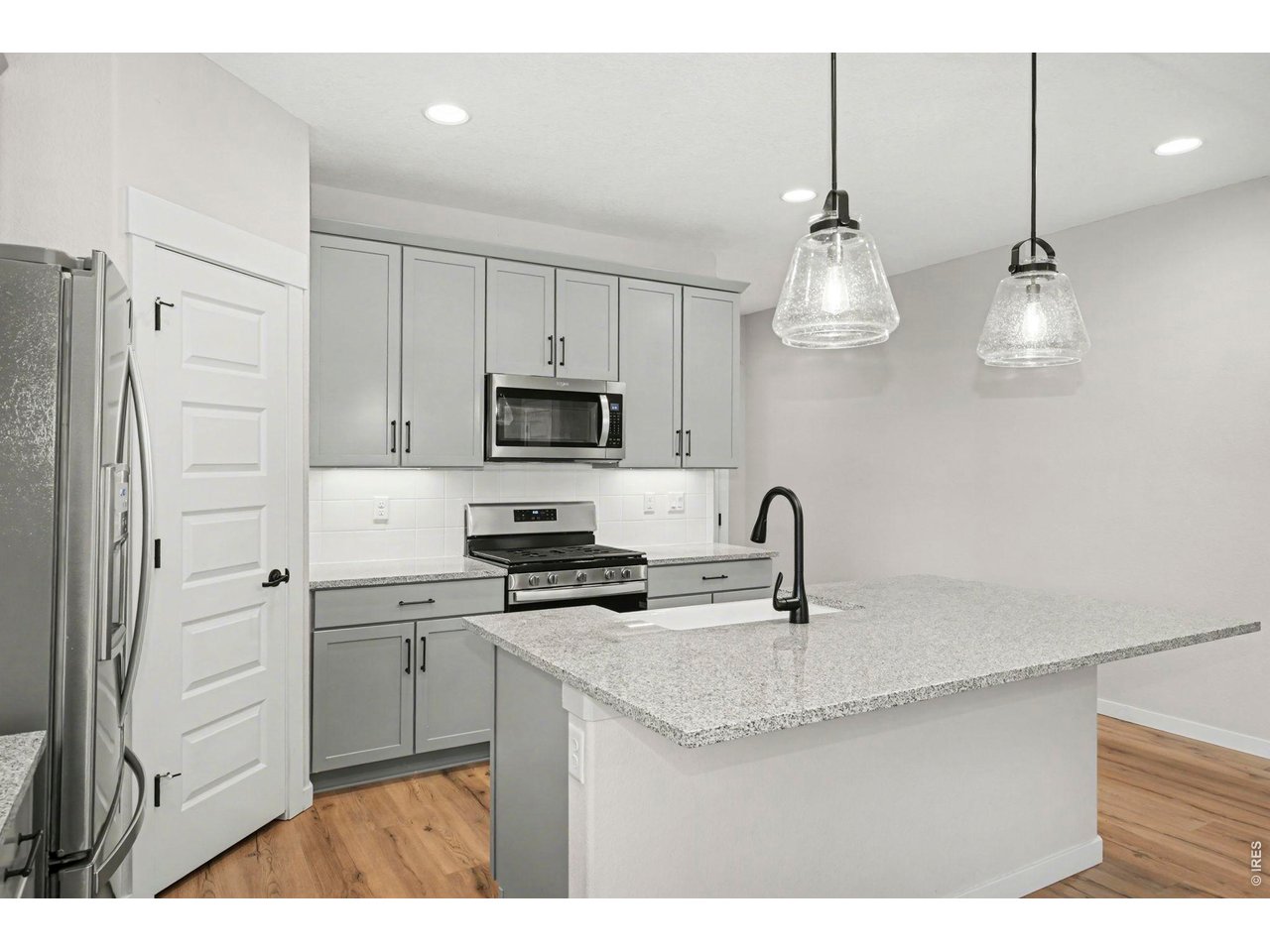 2124 Glean Court Windsor, CO 80550 - Photo 8 of 40 a kitchen with stainless steel appliances a sink stove and refrigerator