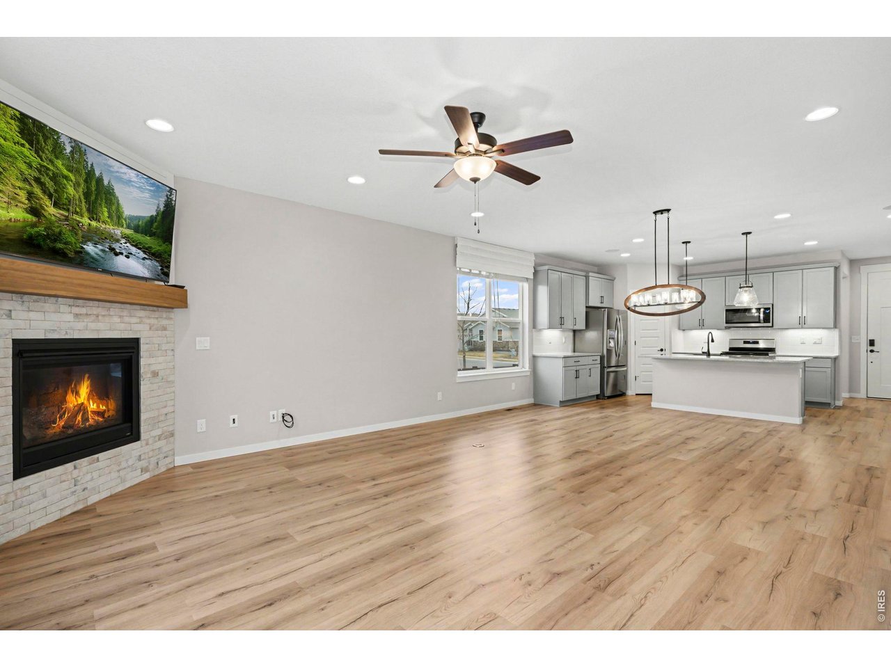 2124 Glean Court Windsor, CO 80550 - Photo 10 of 40 a view of an empty room with kitchen and fireplace