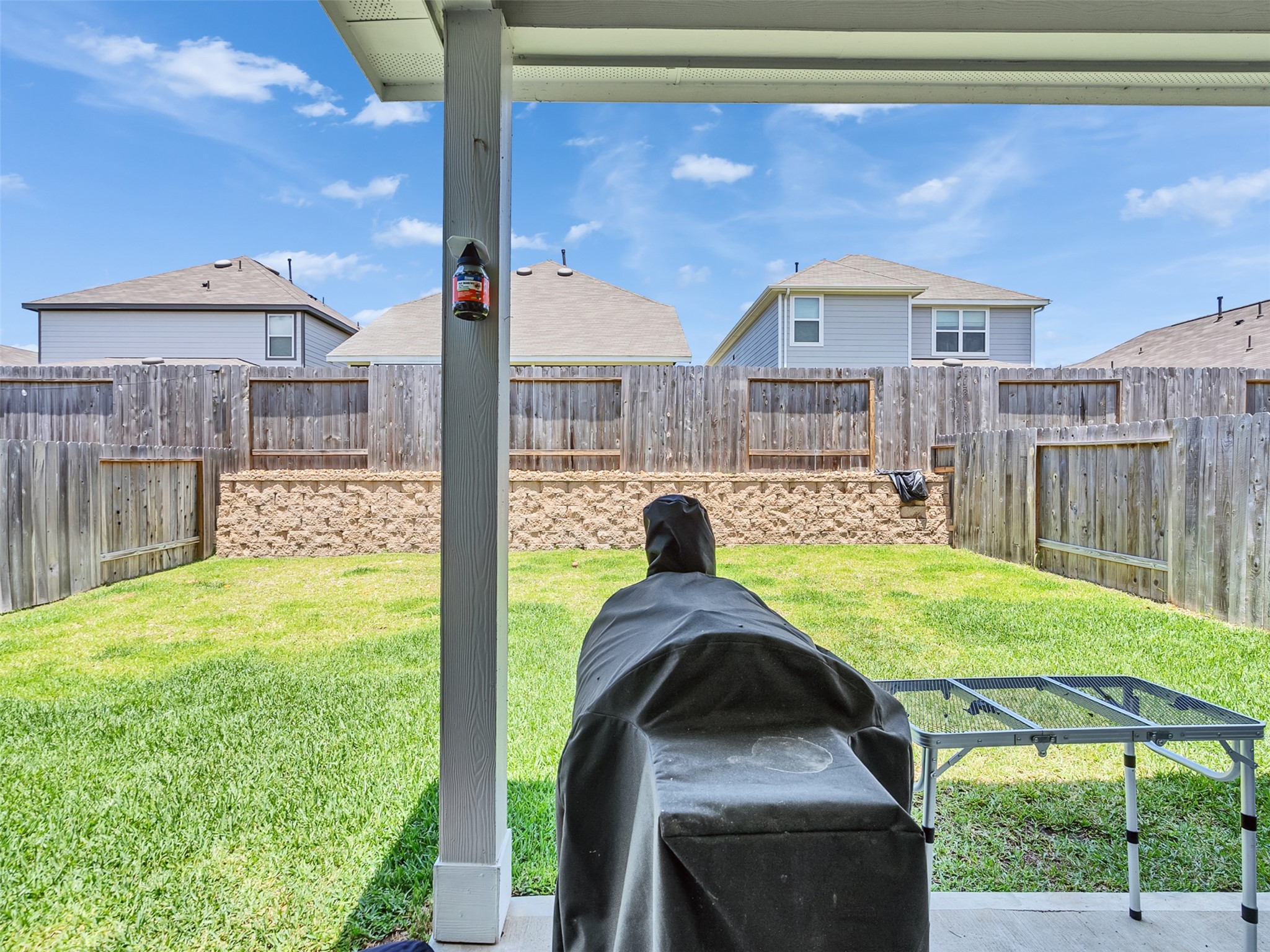 2416 Bluefish Court Conroe, TX 77384 - Photo 13 of 45 a backyard of a house with table and chairs